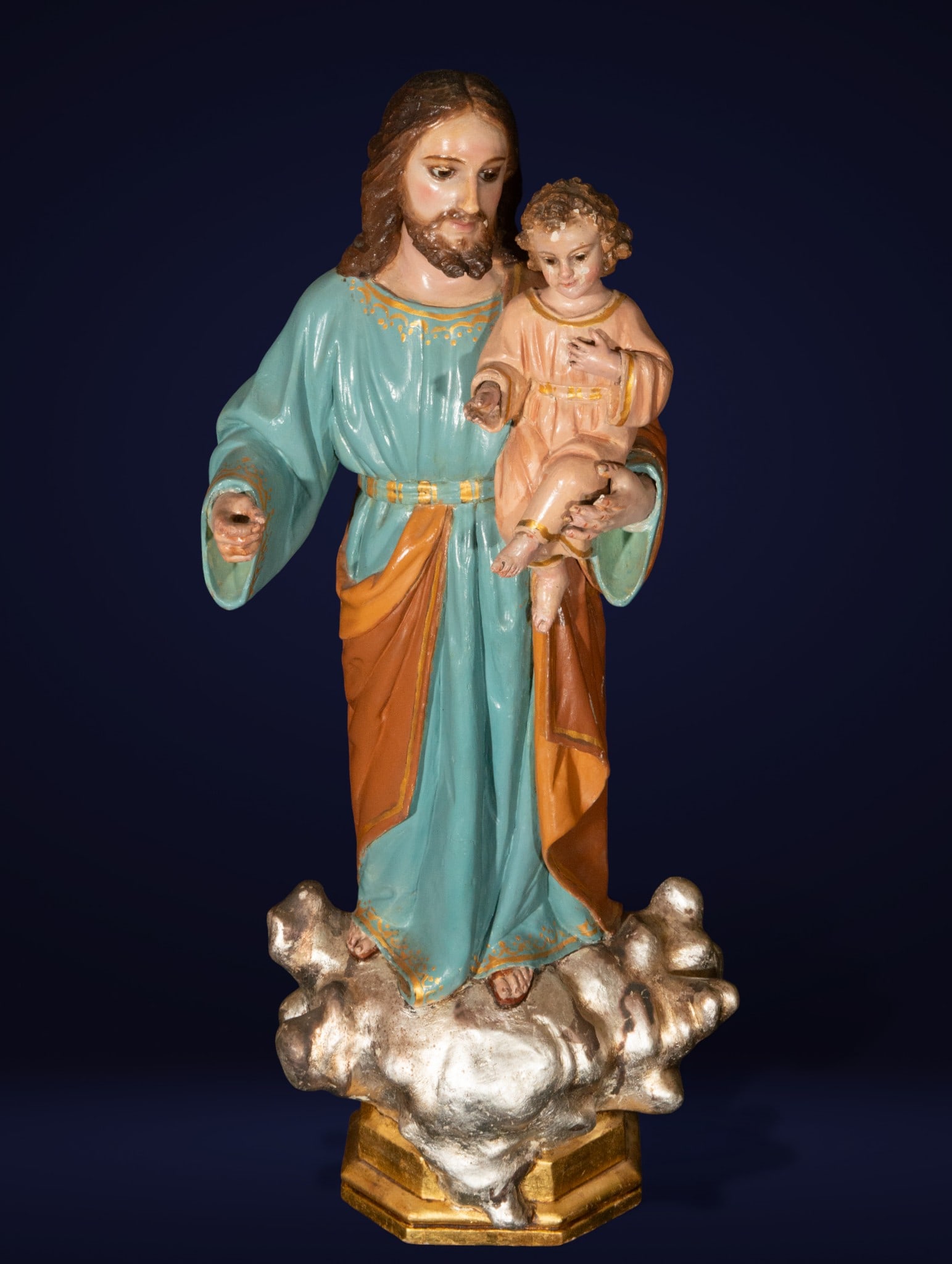 Saint Joseph with the Child. Spanish School. 19th Century.: Carved and polychromed wood. Measures 57 x 26 x 14 cm. Devotional sculpture depicting Saint Joseph holding the Christ Child on a silver cloud. Polychrome in vibrant and golden tones, with a serene exp