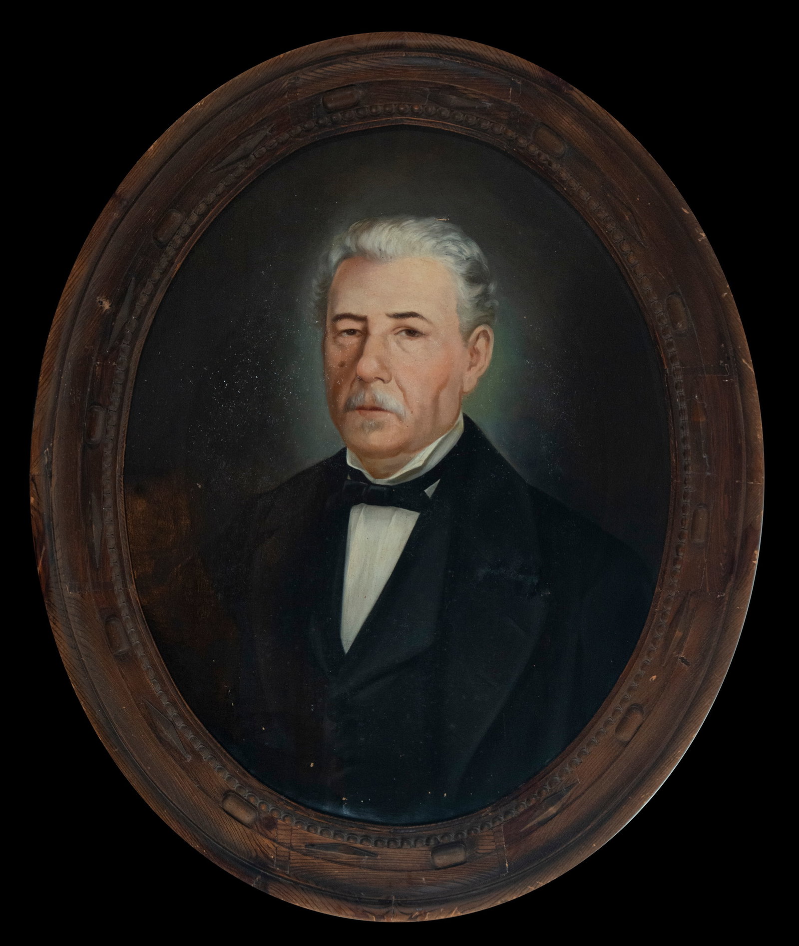 Male Portrait - Spanish School, 19th Century: This 19th-century male portrait, executed in oil on canvas, depicts a gentleman with a serious expression and formal attire, emphasizing his poise and dignity. The dark background enhances the central