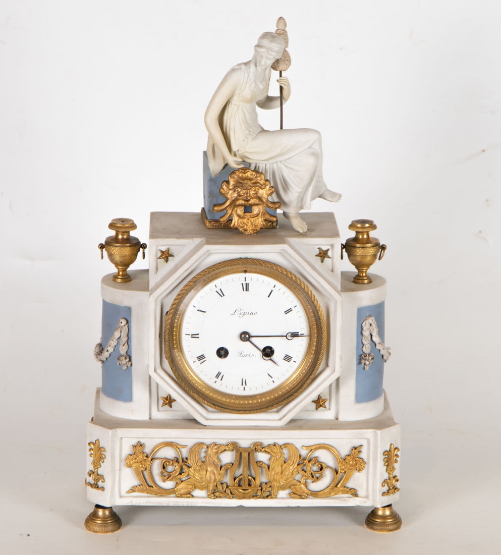 Empire Style Clock in Wedgwood porcelain and gilt bronze, 19th century French school: Measurements: 43 X 25 X 13 cm. Attached bell, pendulum and key.