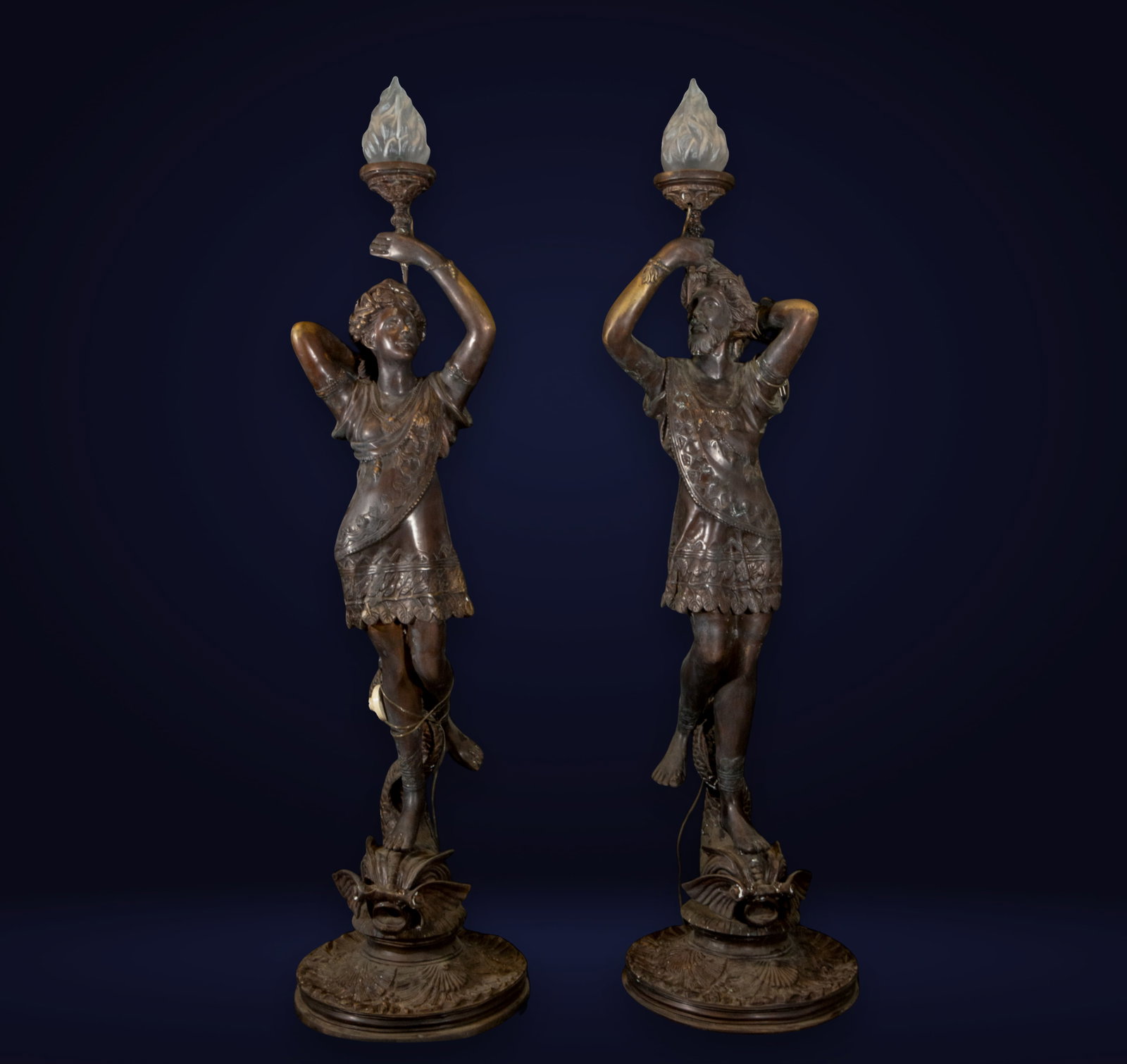 Pair of monumental Art Nouveau torch holders in patinated bronze, late 19th century: In patinated bronze, electrified. Each measures 166 x 43 x 43 cm.