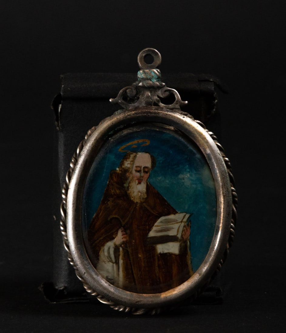 Silver oval pendant reliquary with the Virgin and Saint Francis of Paola painted on glass, 17th: Measurements: 1 x 6 x 4 cm