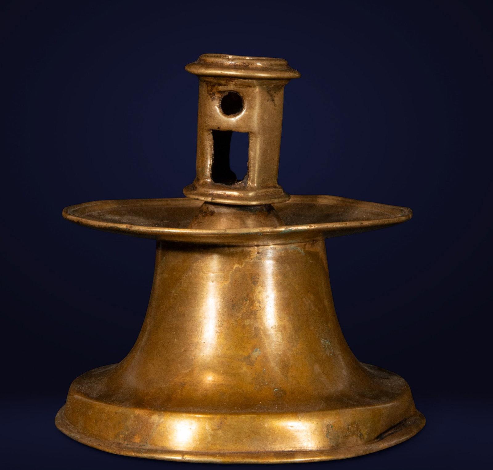 Bronze candlestick, Spain, 16th century: Cast bronze. This truncated-cone candelabra stands on a wide base, giving it solidity and stability. The body, with its austere but firm lines, culminates in a cylindrical stem with rectangular and ci