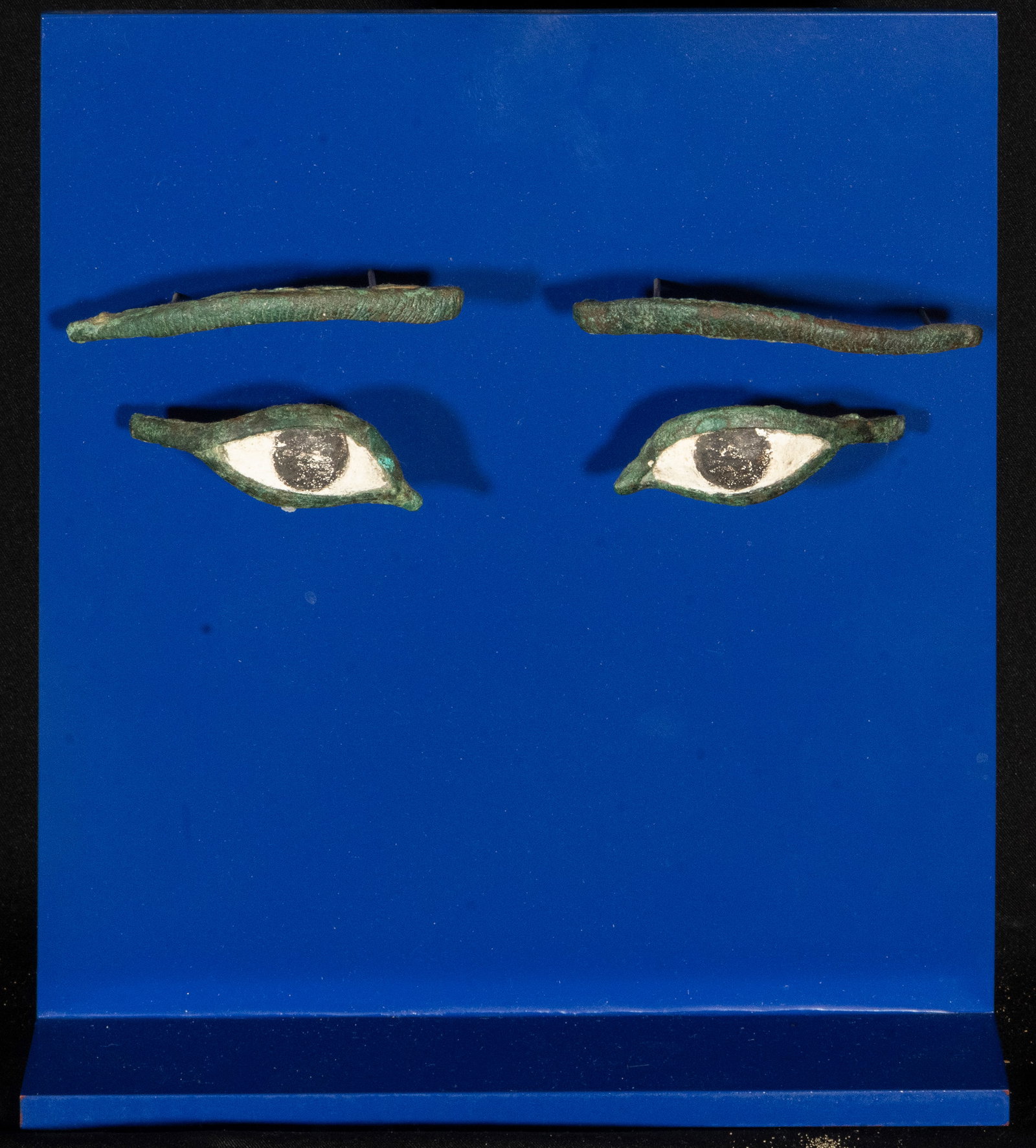 ANCIENT EGYPT Exceptional pair of Egyptian Coffin Eyes - 3rd Century BC: Measurements of each eye: 8 x 3 cm. Measurements of ceiling panel: 25 x 22 cm. Provenance: important private collection in Barcelona.