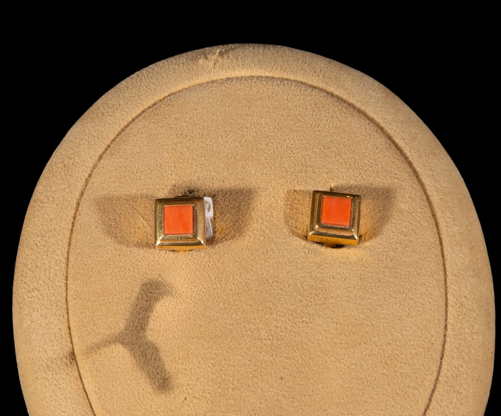 Square coral and 18k yellow gold earrings: Square coral and 18k yellow gold earrings. Each piece features a square coral element suspended from a yellow gold upper section that extends the composition vertically. The clean, linear structure hi
