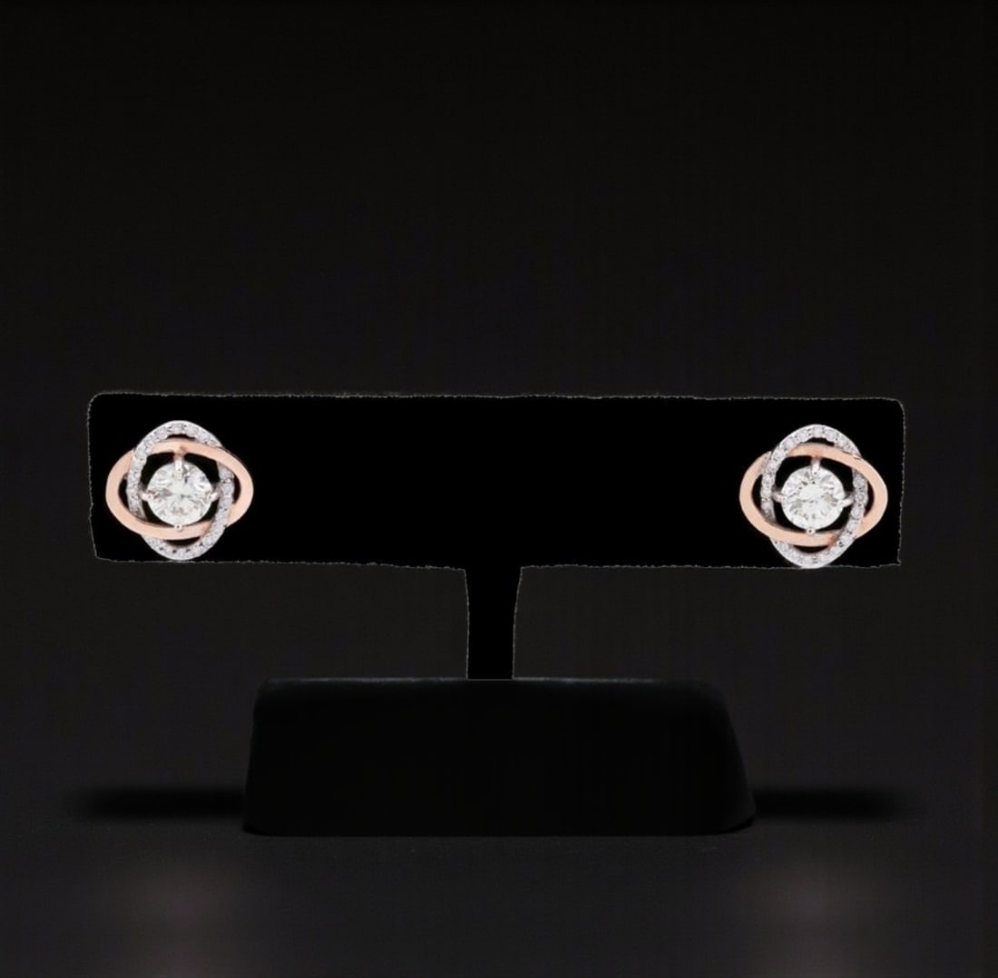 Pair of diamond stud earrings: Pair of stud earrings crafted in 14-karat gold, weighing approximately 3.00 g, featuring an interlocking circular motif fully set with brilliant-cut diamonds. Each earring has a central diamond (two i