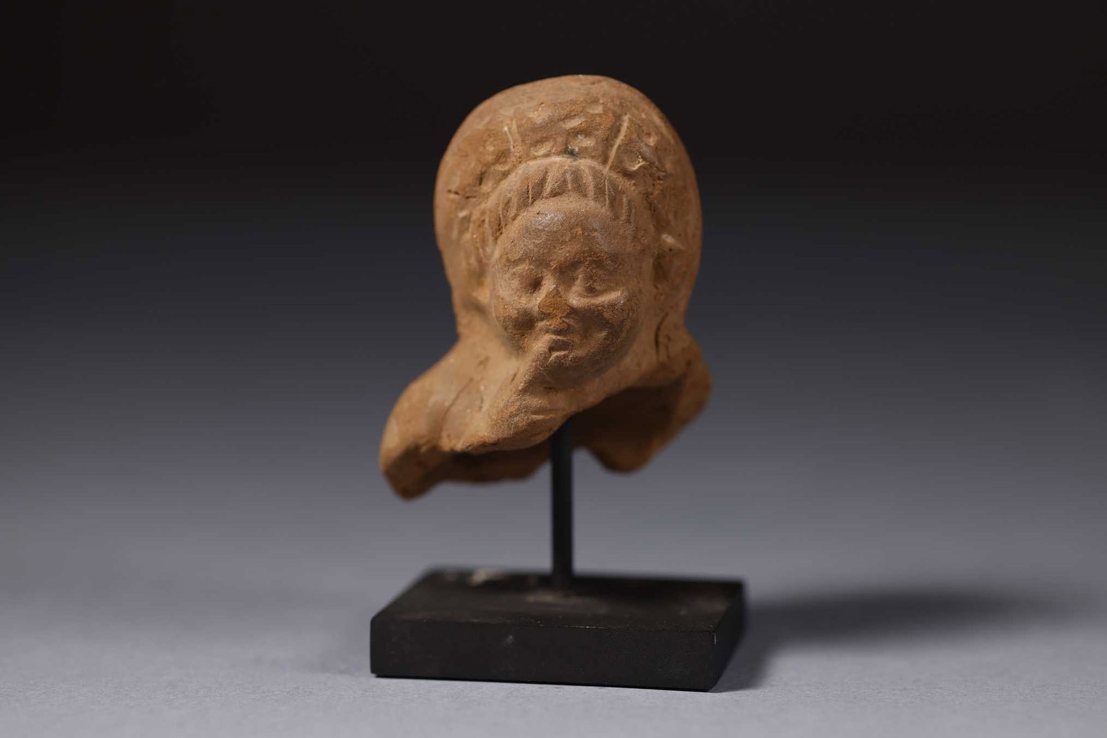 Head of Harpocrates, Magna Graecia, Alexandria, 3rd century BC: 8 x 6 x 4.5 cm, in terracotta