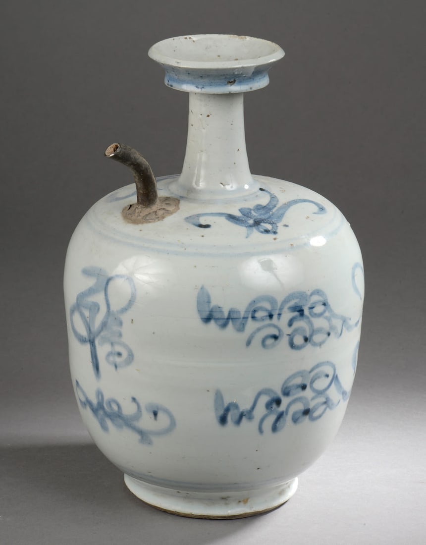 Porcelain jug decorated with cobalt blue glaze on a white ground. Porcelain. Ming Dynasty. 1368 to: JugPorcelain decorated with cobalt blue glaze on a white ground. Porcelain. Ming Dynasty. 1368 to 1644. Height 28 cm x diameter 18 cm. Pouring spout formerly replaced in copper. China - Tibet - Orient