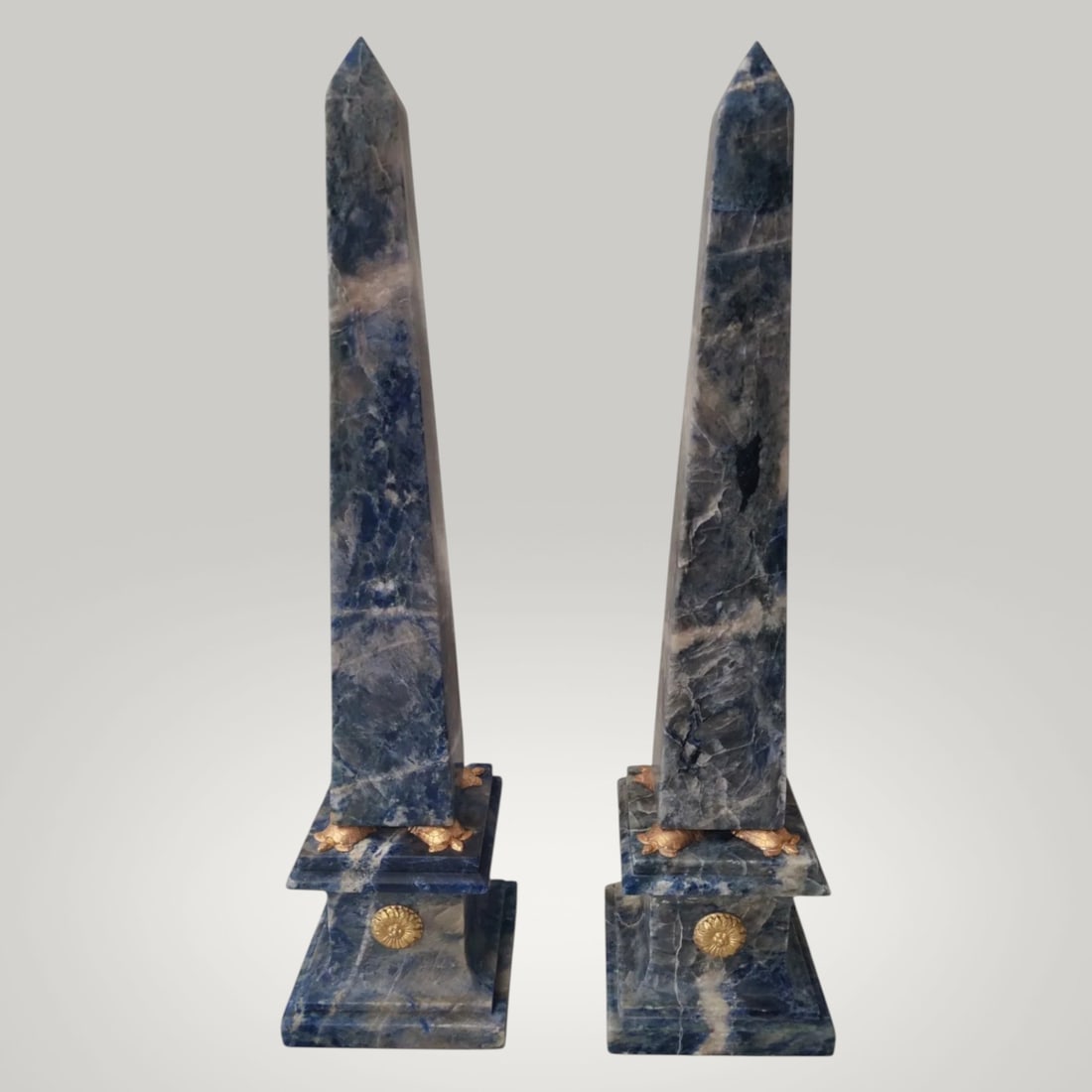 Pair of lapis lazuli obelisks with gilt bronze mounts, Italy, 20th century: Carved lapis lazuli with gilt bronze inscriptions. Measurements: height 53 cm; base 13 × 13 cm (each). A beautiful pair of decorative obelisks made of lapis lazuli, embellished with gilt bronze inscr