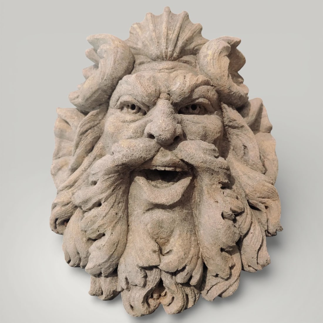 Mask in stone from Vicenza representing a face of a Satyr, Italy, 20th century: Carved Vicenza stone. Dimensions: 40 × 48 × 20 cm. A formidable sculpture representing the face of a Satyr, from Venice, private collection. A mask of extraordinary sculptural quality, also designed