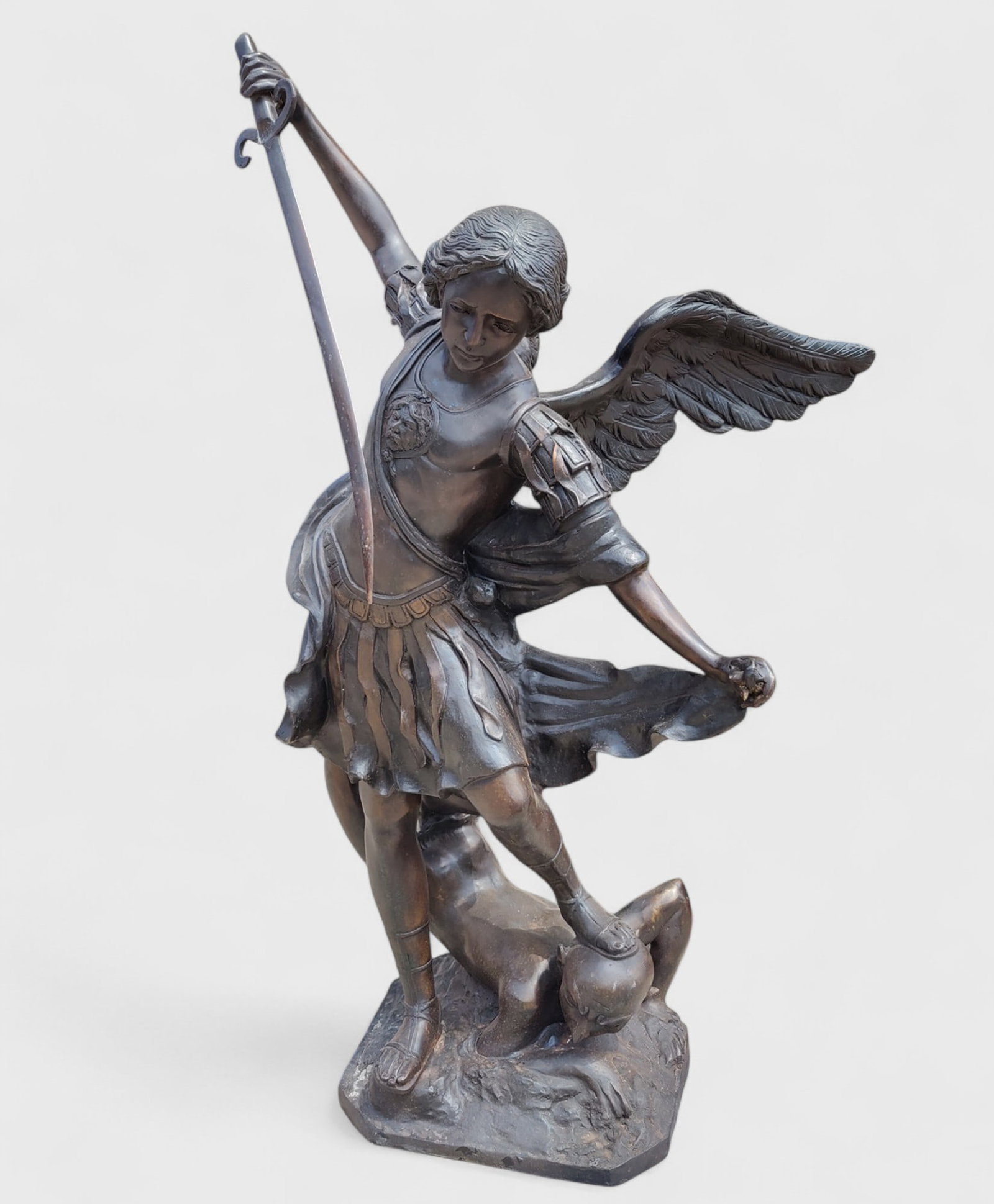 Patinated bronze sculpture depicting Saint Michael the Archangel in the act of killing Lucifer, (1 of 3)