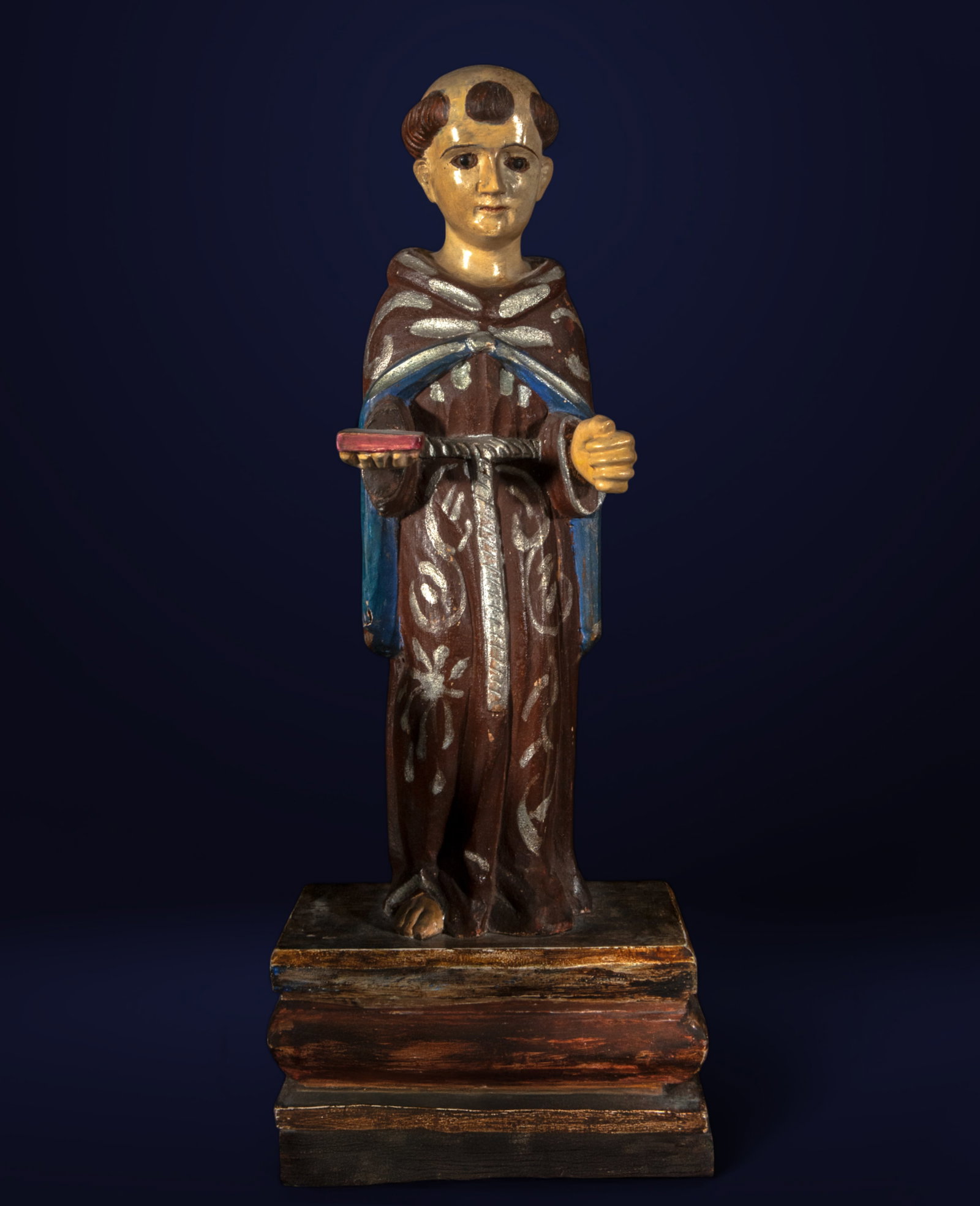 18th Century Colonial School - Saint Anthony of Padua, Polychrome Carved Wood: Dimensions: 44 × 18 × 13 cm Polychrome carved wood. The figure of Saint Anthony of Padua, holding a book in one hand and a rosary in the other, embodies the simplicity and fervor of the sa
