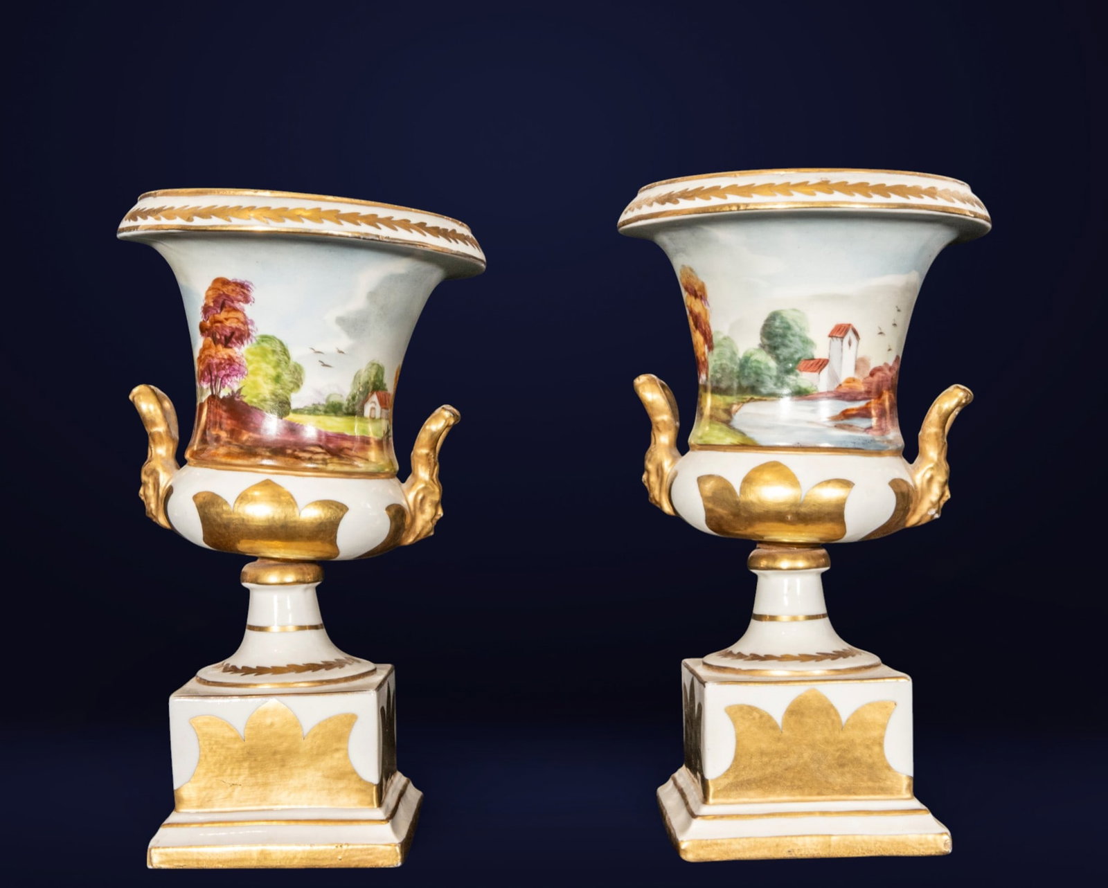Pair of Old Paris style vases, French School, 19th century: Polychrome and gilded porcelain. Measures 24 x 14 x 14 cm. Pair of neoclassical vases with flared bodies, gilded side handles, and square bases, decorated with idealized landscapes of architecture, tr
