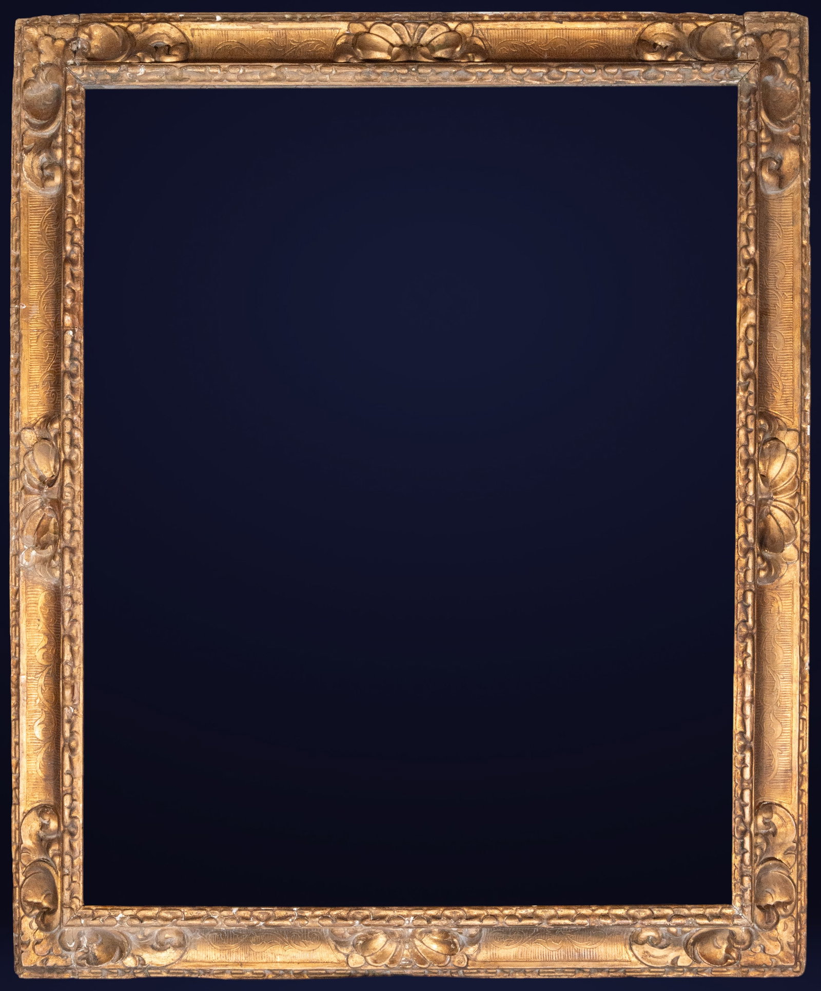 Carved and gilded frame, Spanish school, 18th century: Carved and gilded wood. Dimensions: 124 x 102 cm; 124 x 102 cm. Rectangular frame with continuous vegetal relief decoration and elegant molding, designed to showcase stately works. The carving feature