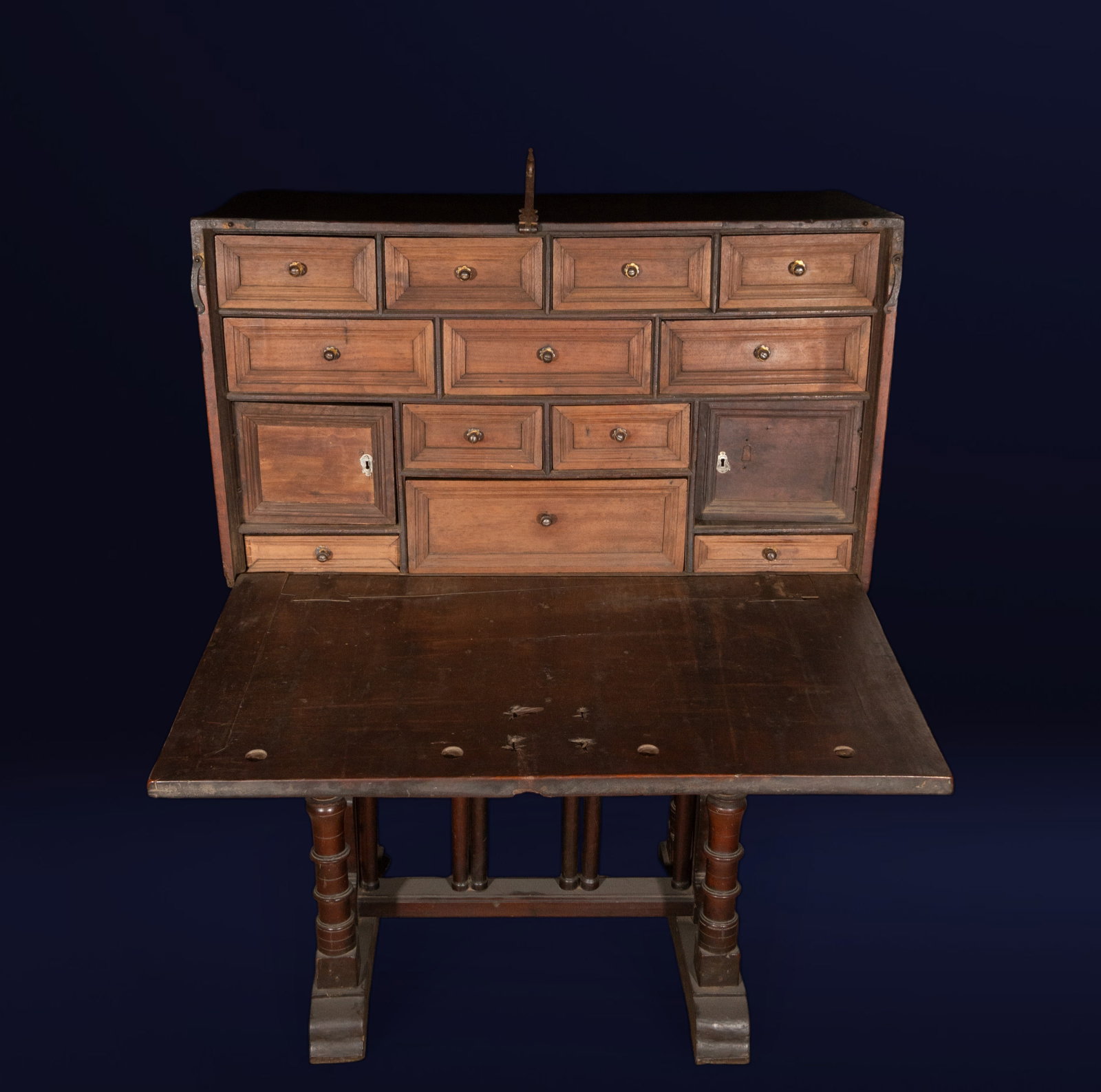 Bargueño, Spanish school, 18th century: Walnut and metal fittings. Dimensions: Headboard 52 x 93 x 40 cm; Overall: 129 x 93 x 52 cm. A bargueño (a type of writing desk) with an architectural front, a hinged lid, and an interior organized w