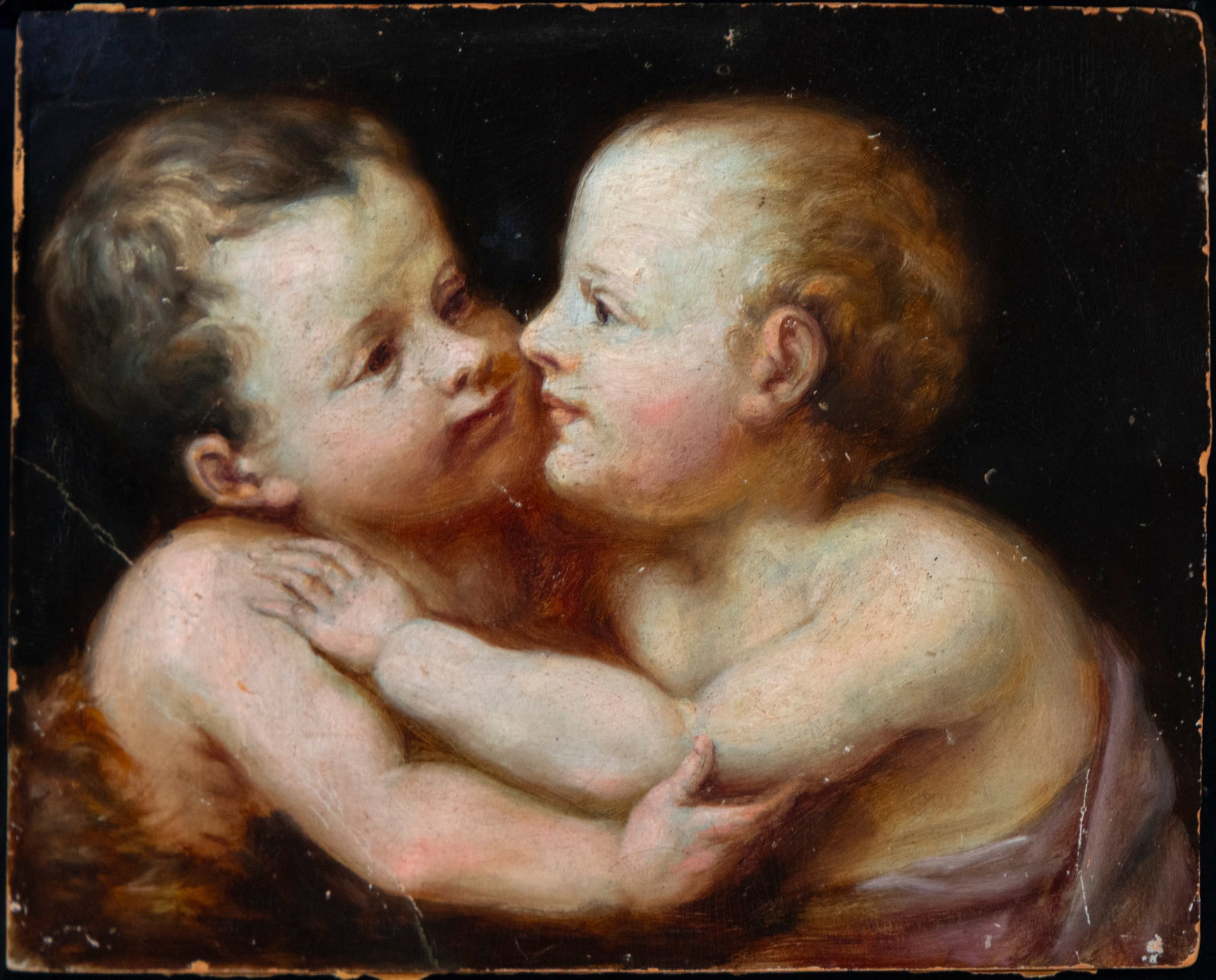 Child Jesus and Saint John the Baptist embracing, Signed and with dedication on the reverse, Spanish: Oil on cardboard. Measurements 22 x 27 cm.