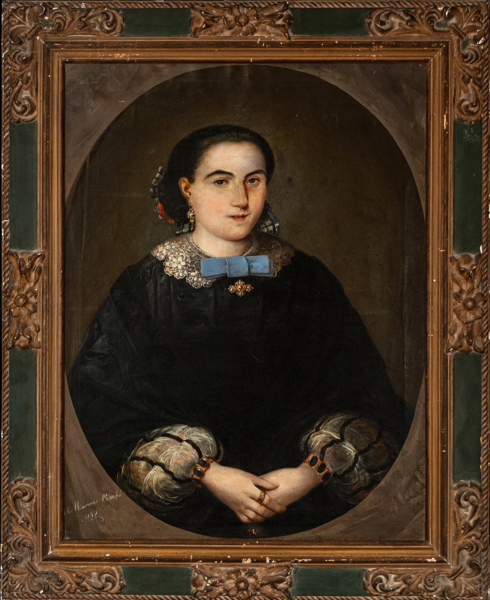 Portrait of a lady, signed Mariano Carbó, Spanish school, 19th century: Oil on canvas. Dimensions 81 x 62 / 103 x 85 cm. Three-quarter portrait of a woman inscribed within a simulated oval, depicting the seated model with her hands delicately clasped. She wears a flowing 