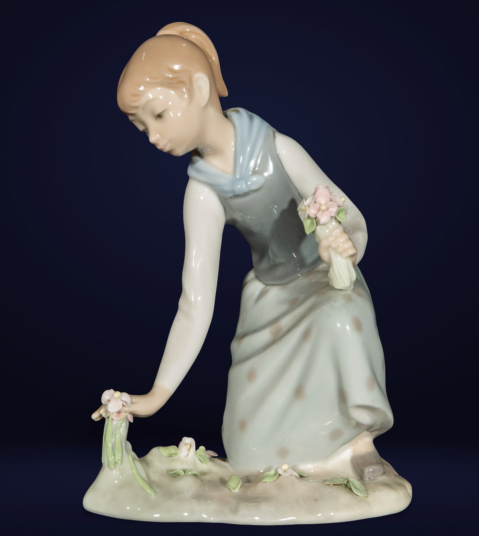 Lladró porcelain figurine of a girl with flowers: Porcelain.