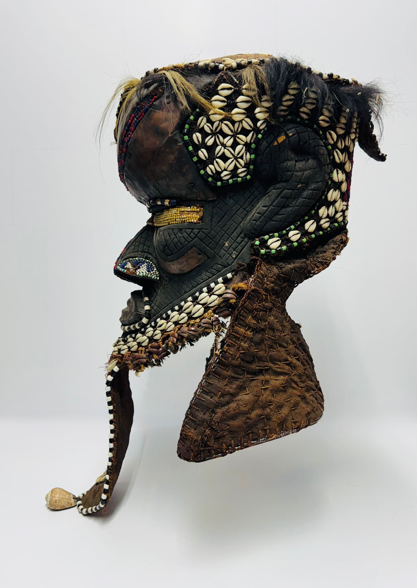 Bushoongo helmet-mask. Kuba Congo: Congo. Wood, metal, cowrie shells, glass beads, fabric, animal skin - 20th century. 69 × 27 cm