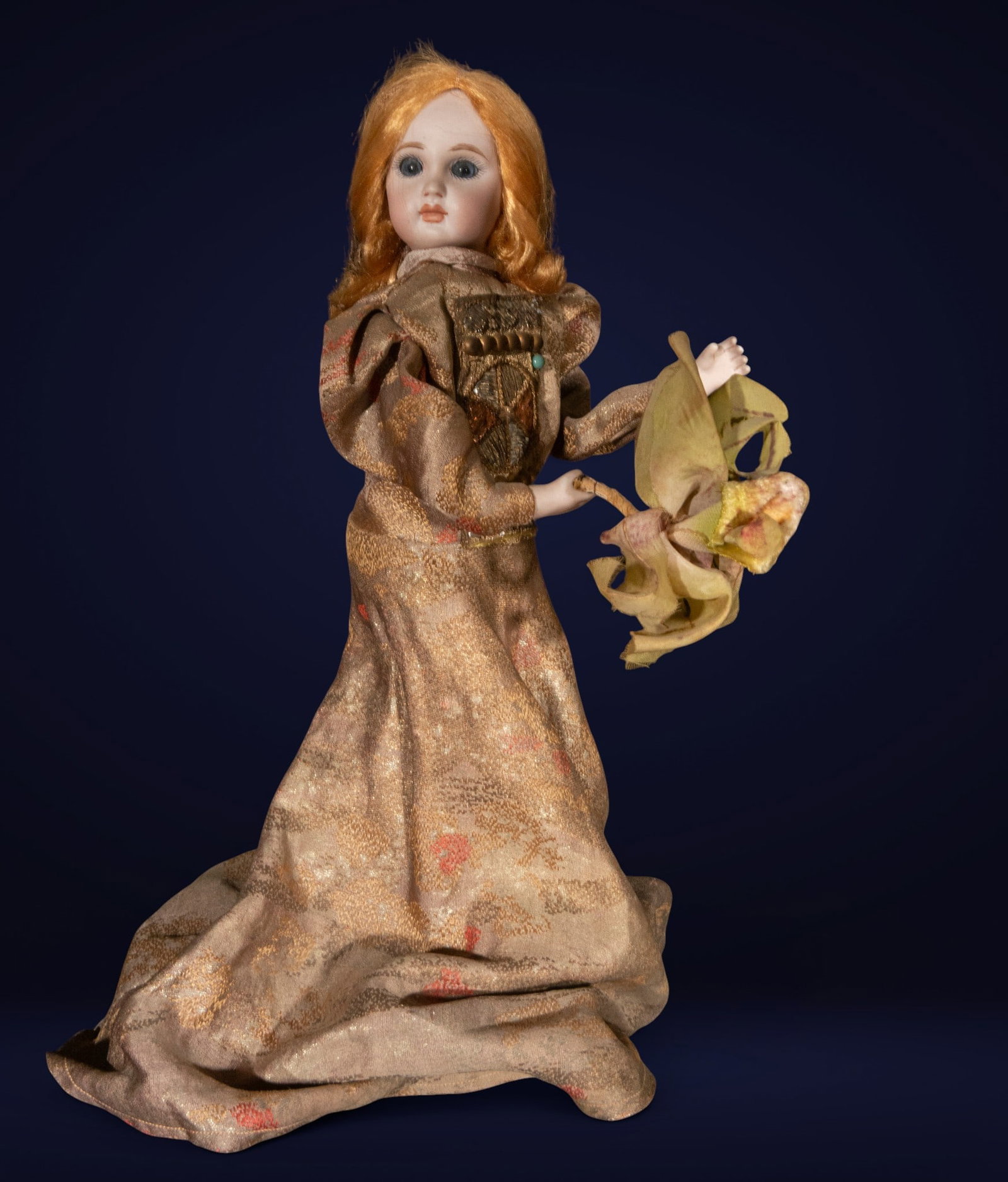 Automaton of a ballerina with a floral bouquet, European School, 19th Century: Automaton depicting a female figure dressed in a flowing damask gown with oriental decorative details, holding a delicate floral bouquet in a dancing pose. The serene porcelain face and large glass ey