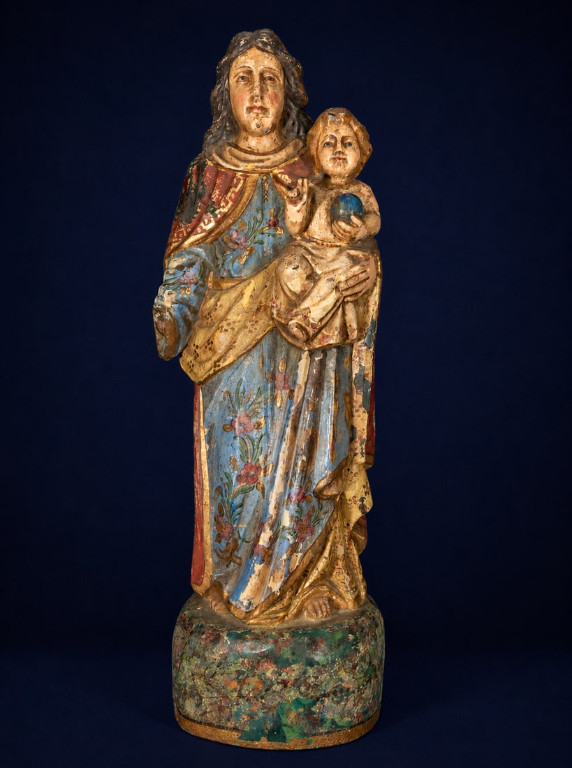 Virgin and Child, Spanish School, 17th Century: Carved and polychromed wood. Dimensions: 82 x 30 x 22 cm. Sculpture of the Virgin Mary holding the Child Jesus in her arms, conceived within a solemn, frontal composition typical of Baroque devotional