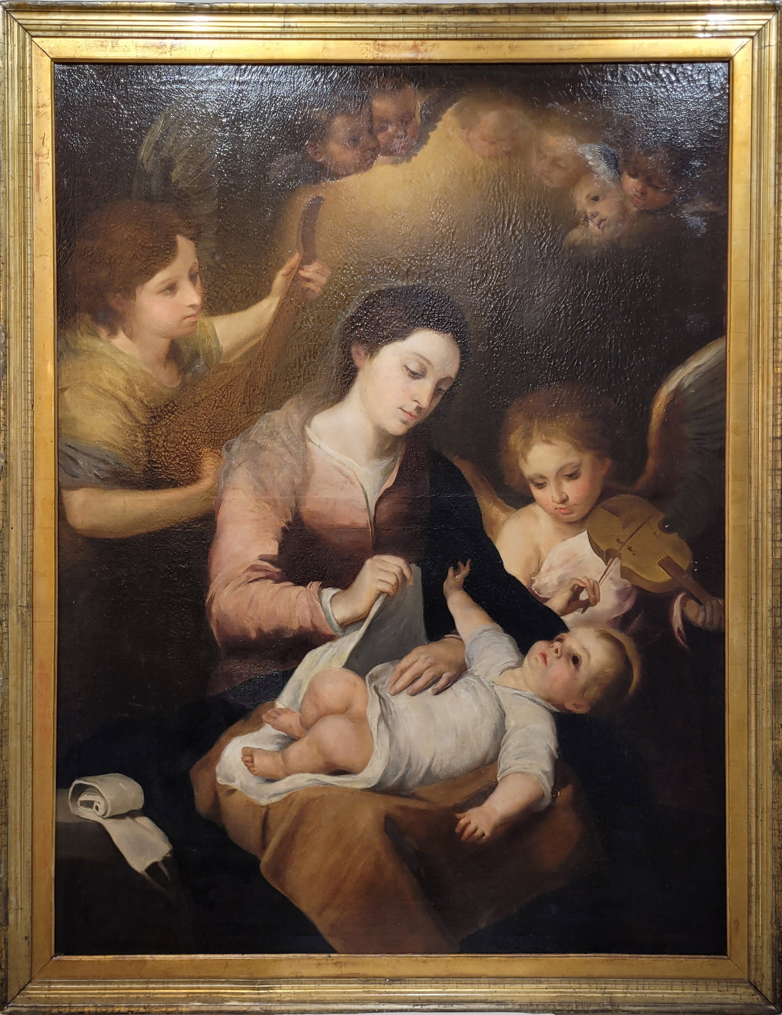 Virgin of the Sash, Sevillian School, 17th-18th Century: Oil on canvas. Dimensions 148 x 116 cm; frame 128 x 100 cm. A devotional scene centered on the seated Virgin Mary holding the Christ Child, while a female figure in a reverent pose approaches from the