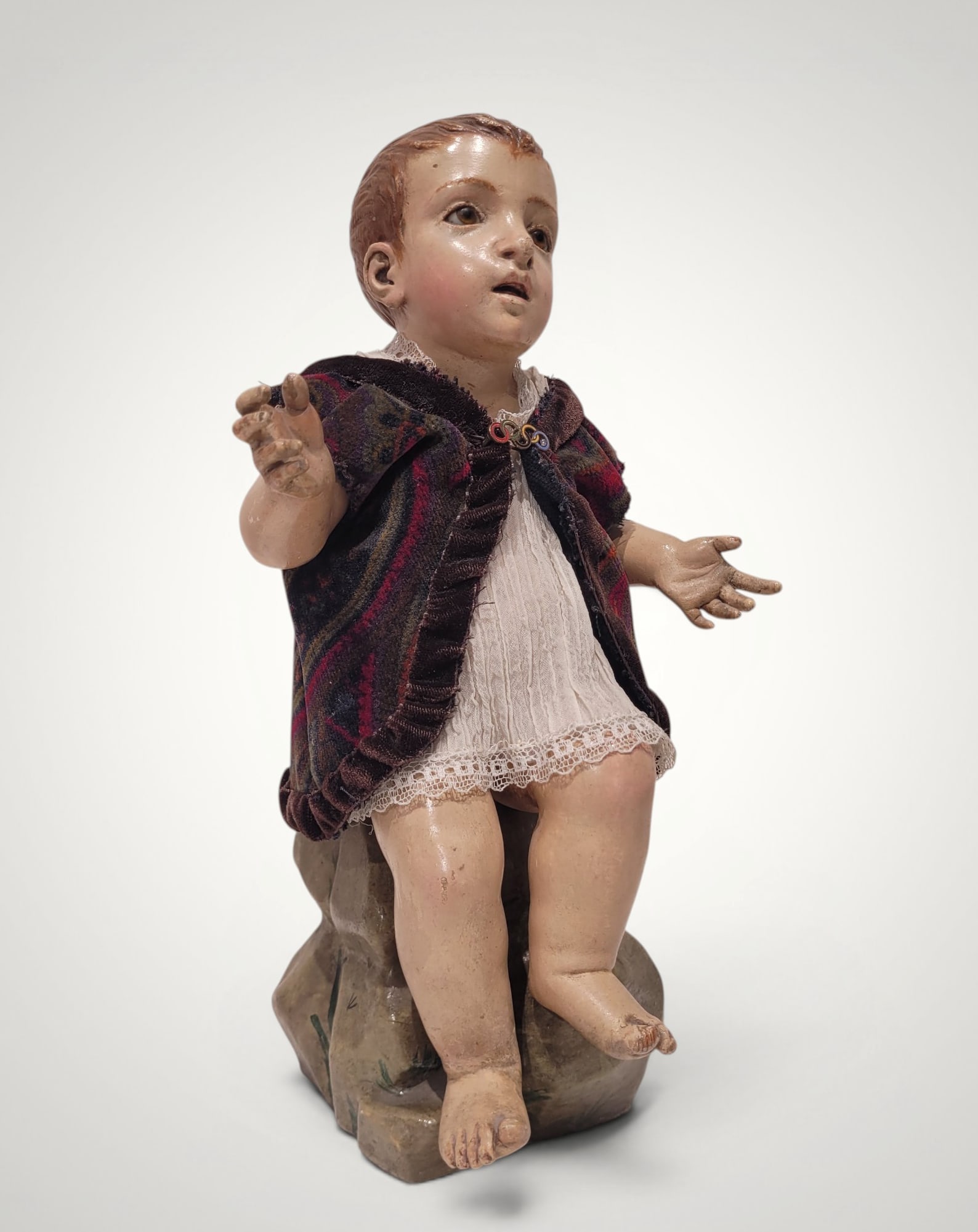 Saint John the Baptist on the Rock, Catalan School, 20th Century: Polychrome sculpture. Measures 26 x 13 x 14 cm. A delicate sculptural representation of the infant Saint John the Baptist seated on a rock, conceived with a tender devotional sensibility and a remarka