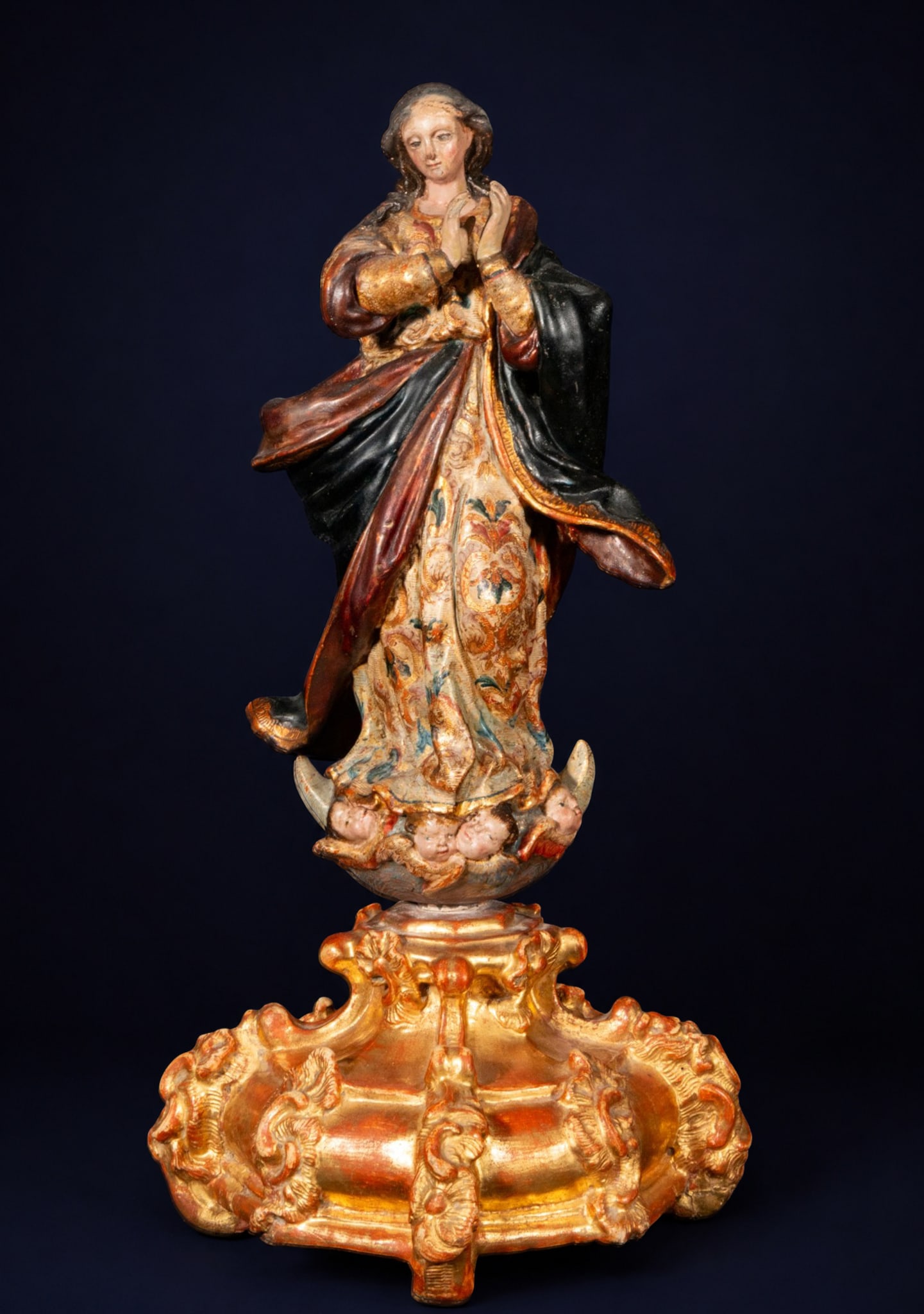 Immaculate Conception, circle of La Roldana, Spanish School, late 17th - early 18th century.: Polychrome terracotta sculpture. Dimensions: 44 x 25 x 25 cm. Image of the Immaculate Conception standing on a base of clouds and cherub heads, with her hands clasped in prayer and her gaze raised. Th