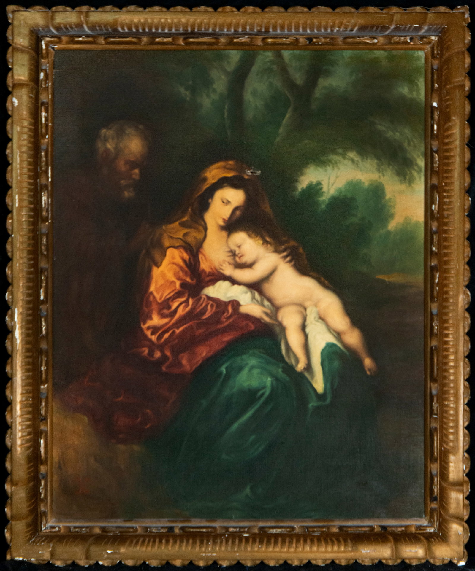 Virgin and Child, European School, 20th Century.: Oil on canvas. Dimensions: 78 x 61 cm; 90 x 75 cm. An intimate devotional scene featuring the Virgin Mary holding the sleeping Christ Child on her lap, while the figure of Saint Joseph emerges discree