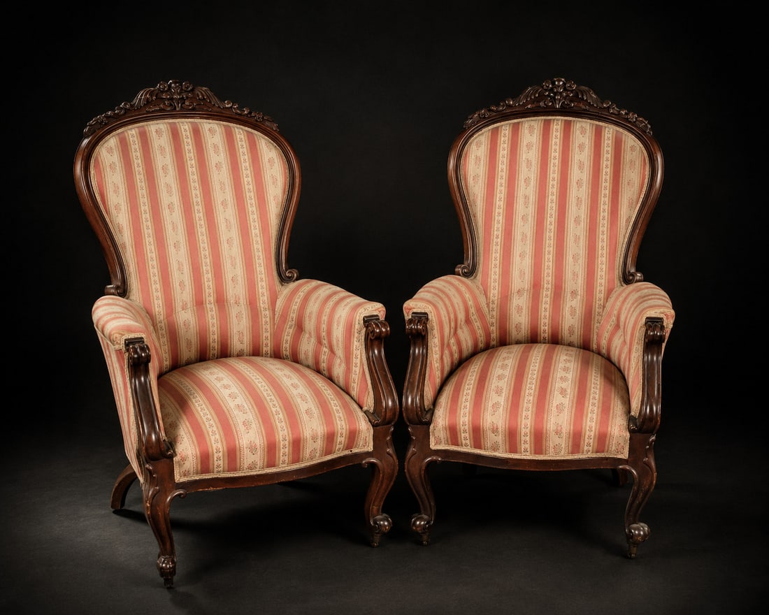 Pair of Isabeline armchairs, French School, 19th Century: Carved mahogany and textile upholstery. Dimensions: 116 x 74 x 91 cm. An elegant pair of high-backed armchairs crafted from mahogany, featuring a sinuous, curvilinear structure inspired by 19th-centur
