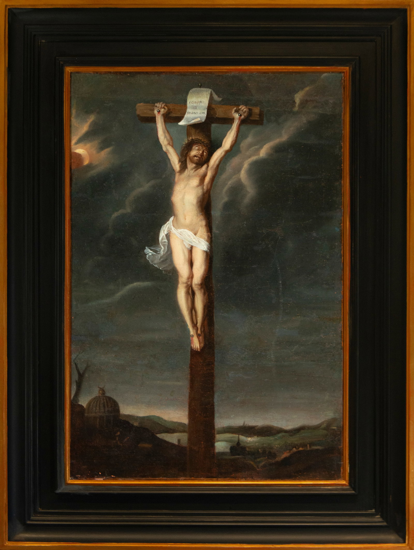 Christ crucified. Spanish School. 17th century.: Oil on canvas. Dimensions 93 × 61 cm. Christ appears nailed to a wooden cross, isolated against a stormy sky that accentuates the drama of the scene. The anatomy is carefully modeled, highlighting th