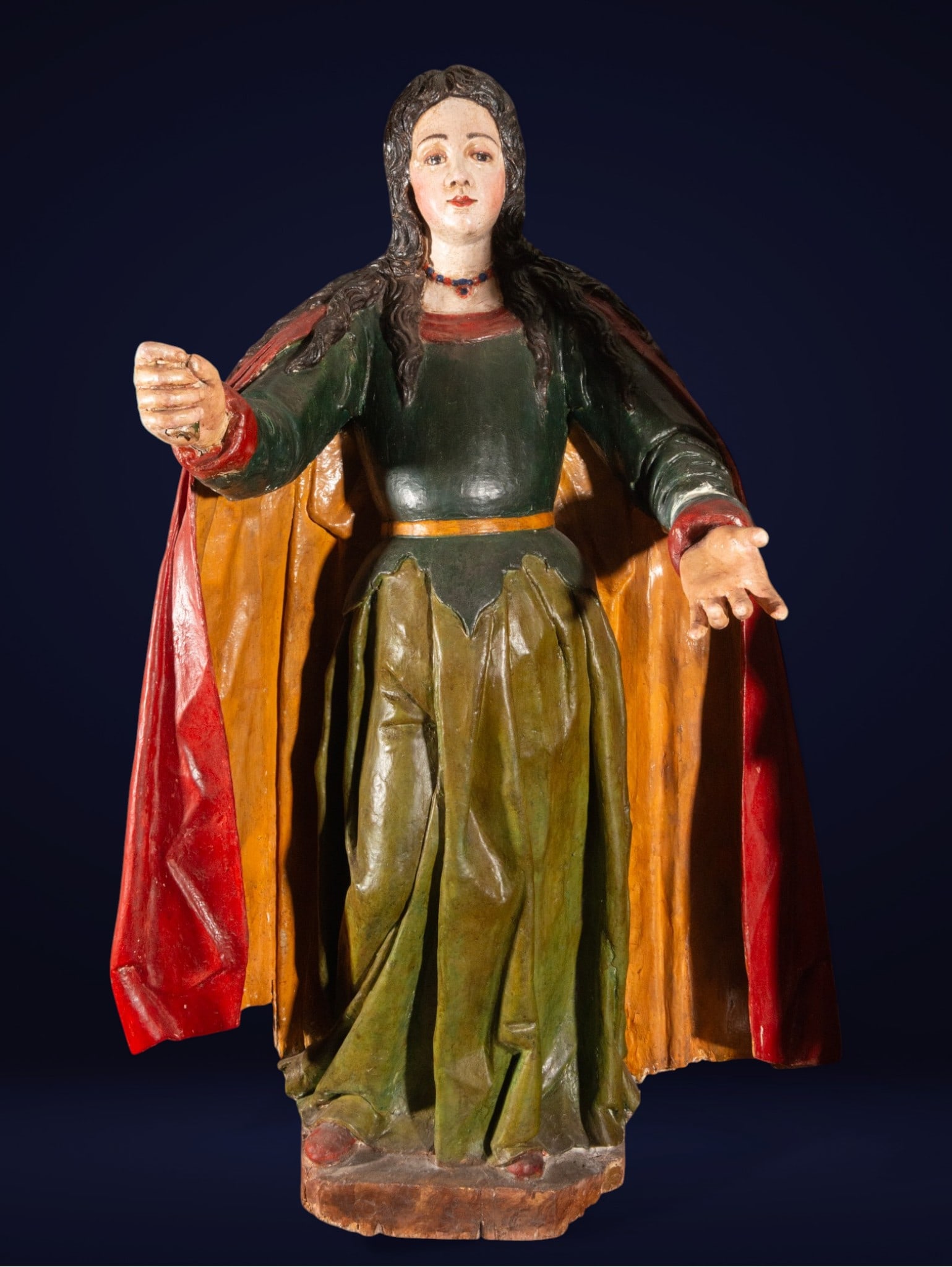 Santa Elena, Italian-German School, 17th Century: Wooden carving. Measures 119 x 67 x 46 cm. Standing female figure, with her right arm extended holding a small object and her left hand open in a gesture of offering. She has long, dark hair, a green 
