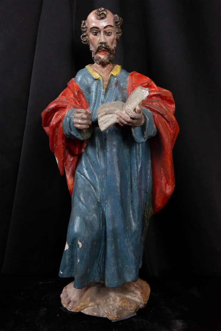 Wooden sculpture of Saint Barnabas, 17th century: Wooden carving of Saint Barnabas with the Gospel of Matthew in his hand. It has areas with repainting. Measurements: 44 x 19 x 14 cm.