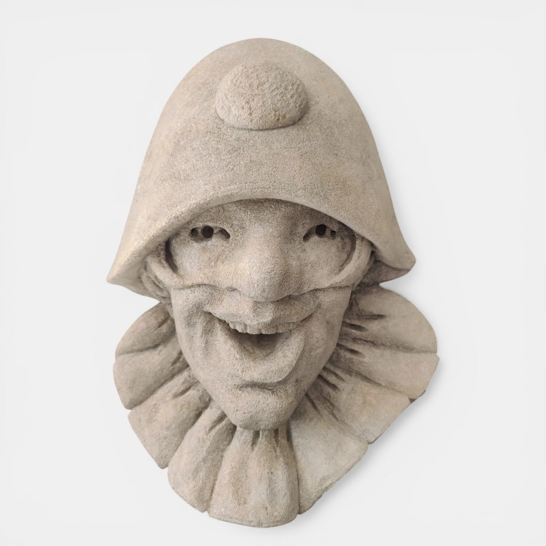 Carnival mask or fountain mouth with Harlequin in stone, Vicenza, Italy, 19th-20th century: Carved Vicenza stone. Dimensions: 33 x 45 x 20 cm. A unique sculptural mask representing Harlequin, identified by his half-mask, flat nose, and bulging forehead, in an interpretation of great expressi