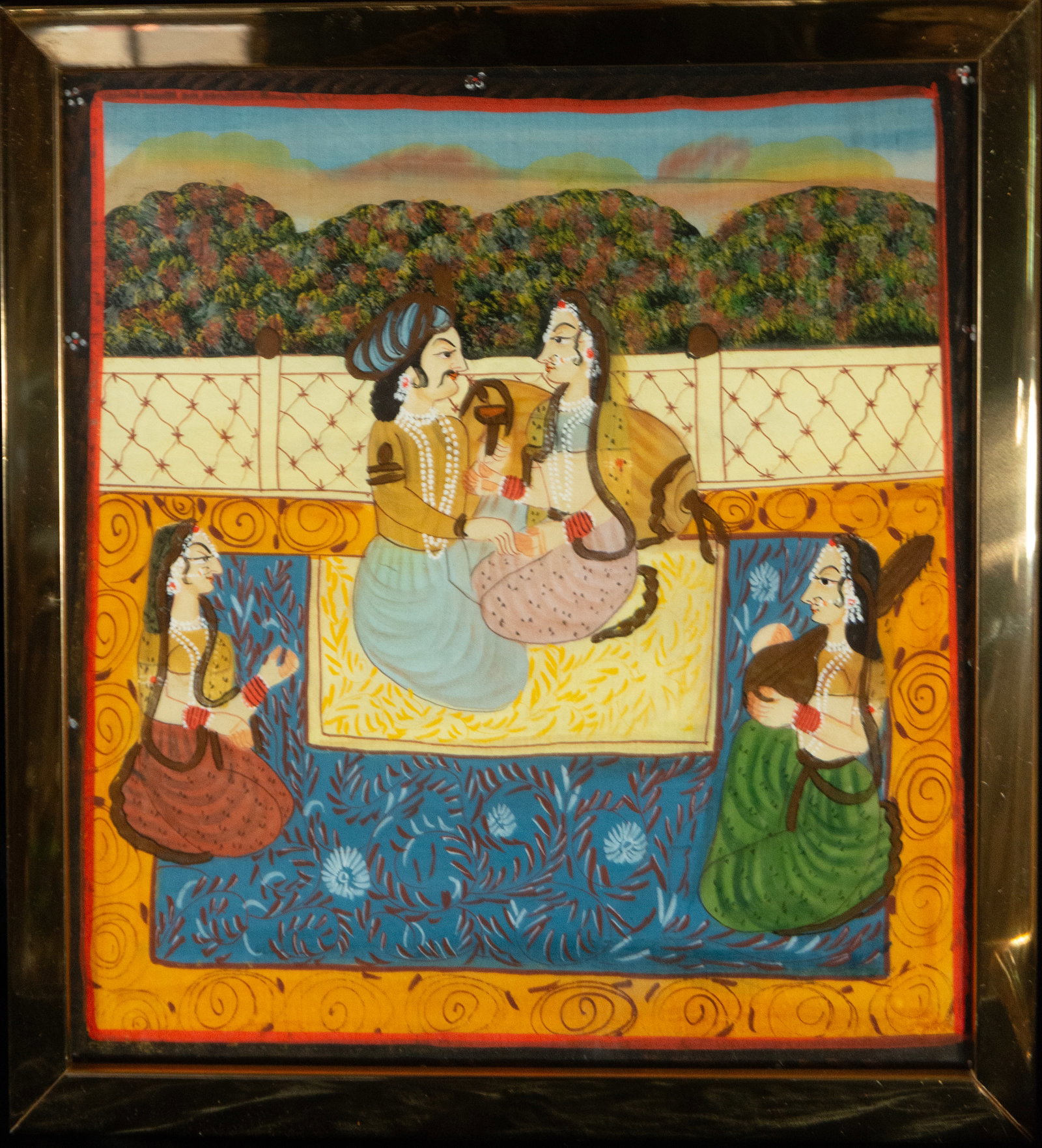Elegant Mughal scene at an Indian school, 20th century.: Indian painted silk. Measures 33 x 33 cm; with frame 37 x 36 cm. Square composition with a noble couple seated in the center of a carpeted terrace, flanked by two female figures holding fans or instru