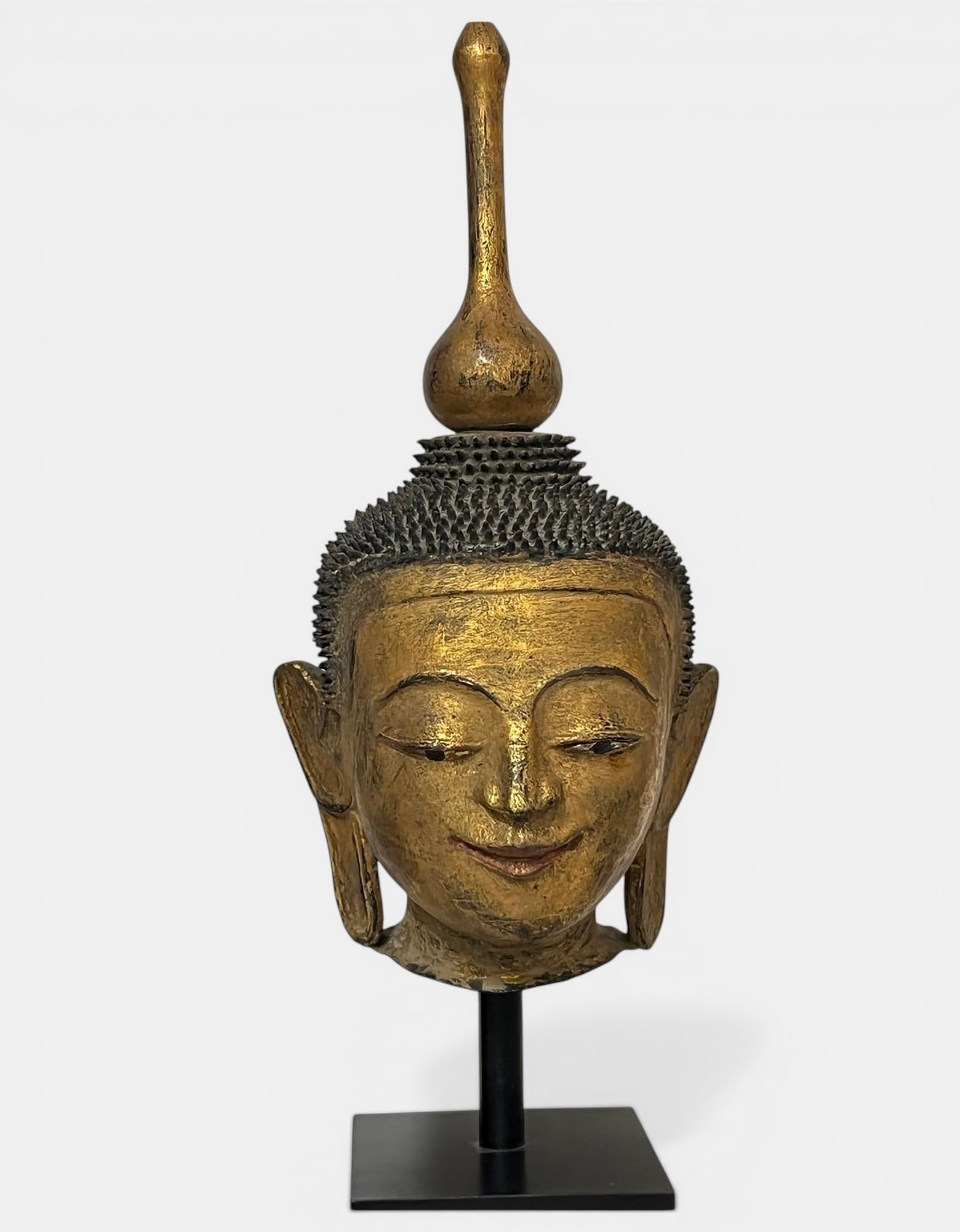 Buddha head with serene expression and downcast gaze (1 of 4)