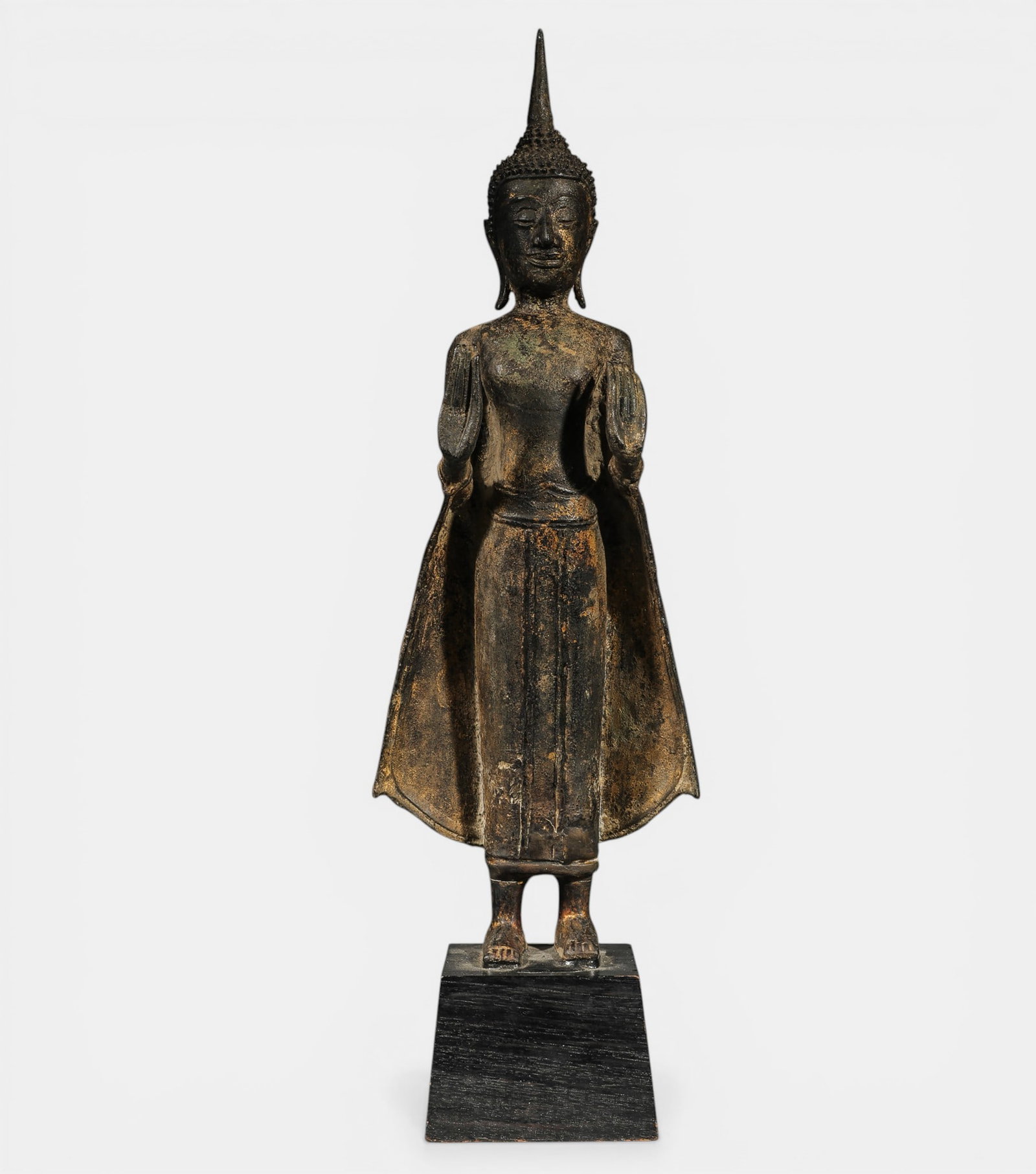 Buddha standing, unfurling the cloths of his monastic robe, Uttarasangha (1 of 3)