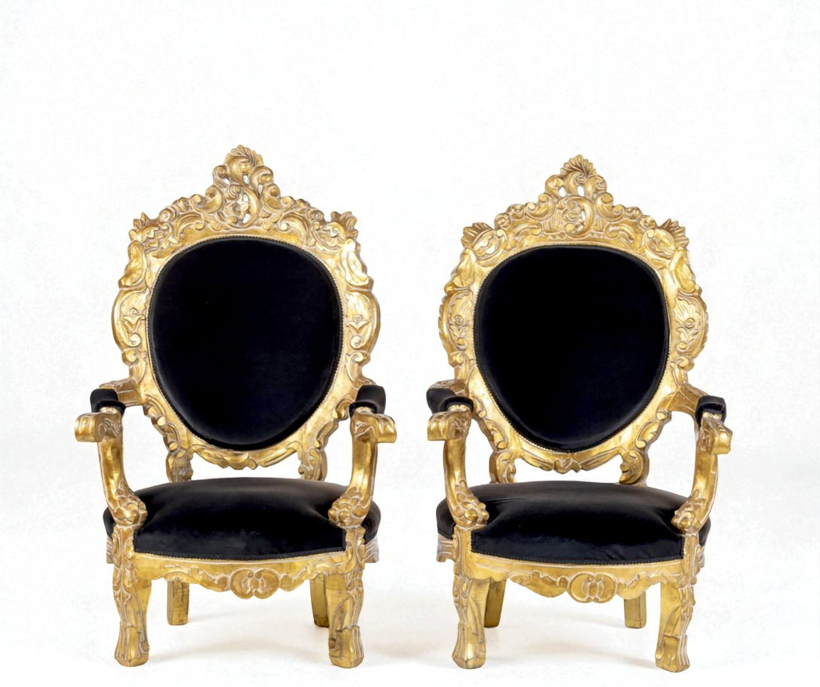 Pair of large armchairs. French School. 19th century.: Carved and gilded wood with applied gold leaf. Dimensions: 129 x 74 x 66 cm. This pair of imposing armchairs features a richly ornamented, monumental structure with an oval backrest framed by elaborat
