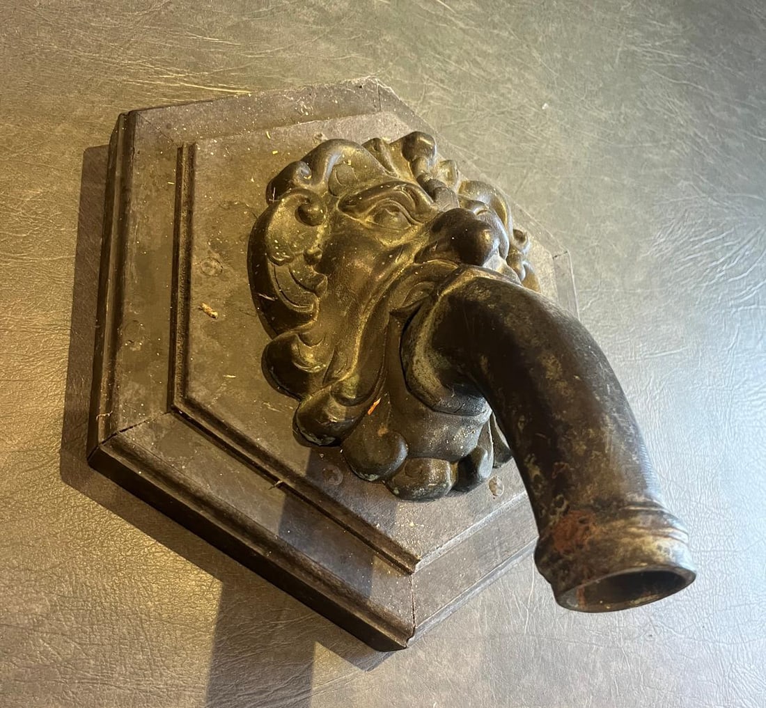 Lion mask gargoyle with cylindrical drainpipe (1 of 5)