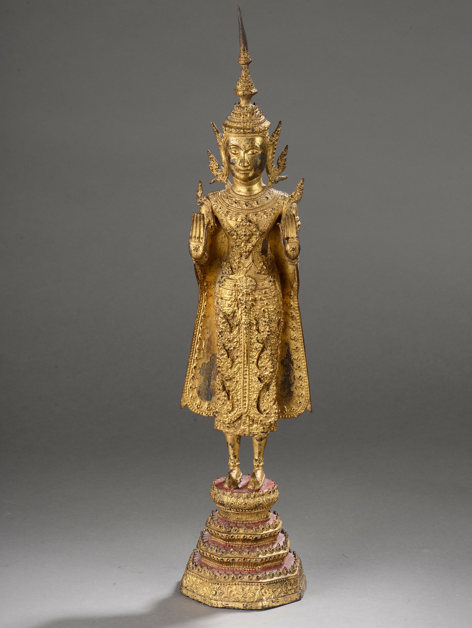 Buddha standing in abhayamudra richly dressed with uttarasanga and high tiara: Standing on a stepped pyramidal pedestal. Lacquered and gilded bronze. Thailand. Kingdom of Ratanakosin. 19th century. 49 cm. Lot in international warehouse (within the EU). Intra-EU shipment: no impo