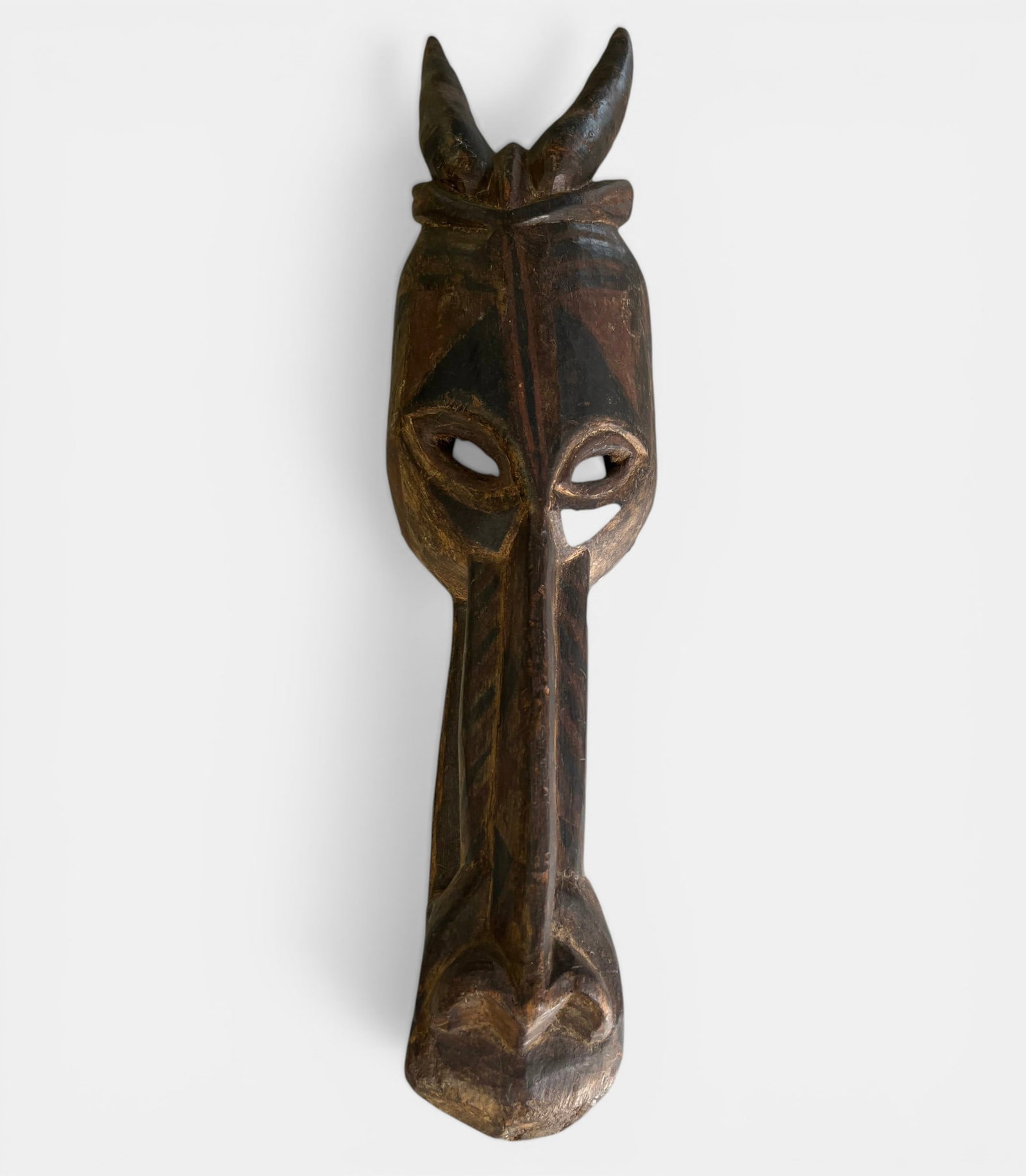 Large animal mask in polychrome wood with stylized bovid head (1 of 3)