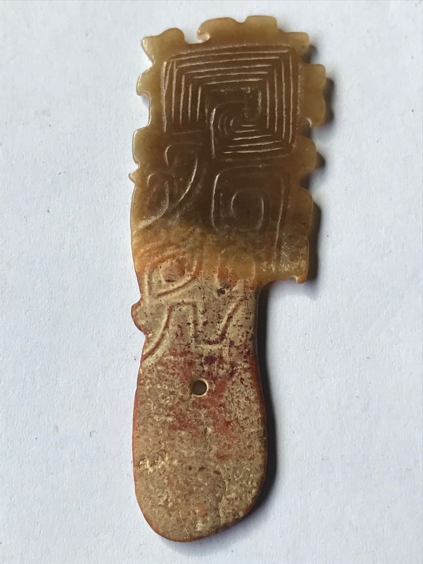 Ornamental or ritual jade leaf, China. Shang Dynasty: Ornamental or ritual leaf, funerary offering carved from brown nephrite jade with golden highlights, with an ancient patina, traces of natural alteration, silt, and excavation patina consistent with l