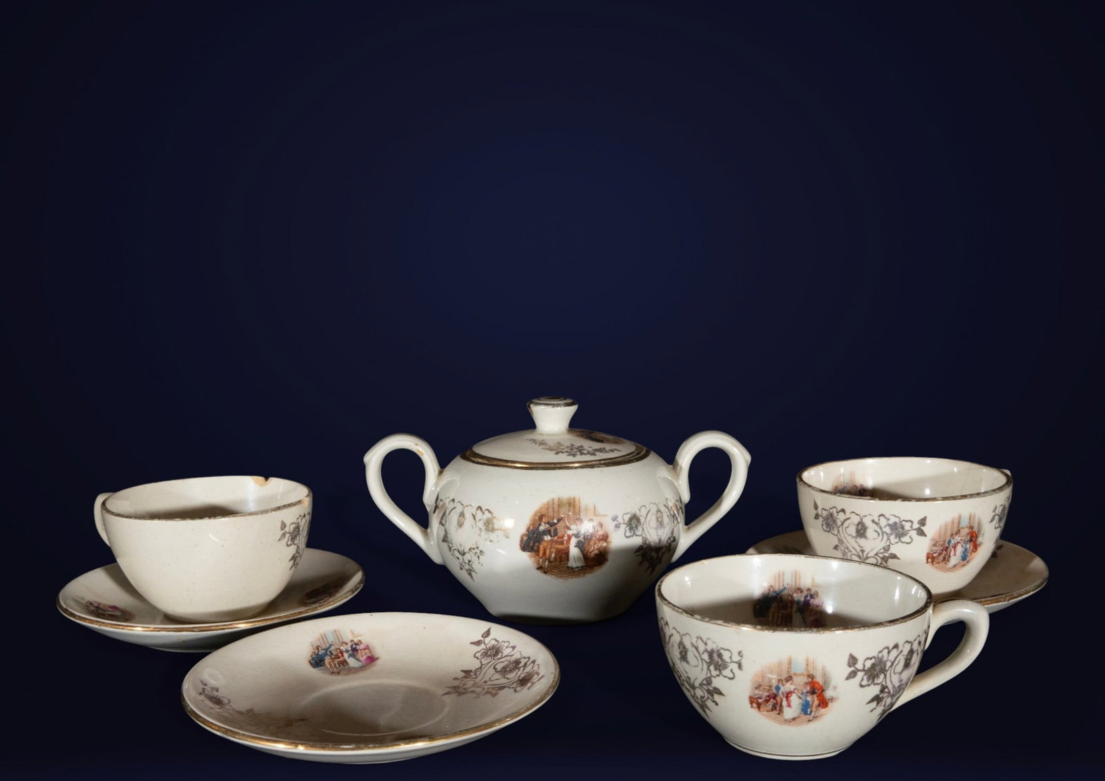 La Cartuja ceramic set with gallant scenes, Spanish school, 20th century.: La Cartuja ceramics. Measures 10 x 7 x 10 cm / 7 x 14 x 14 cm. Set of cup, saucer, sugar bowl, and bowls in white earthenware decorated with small gallant scenes in cartouches and floral garlands in s
