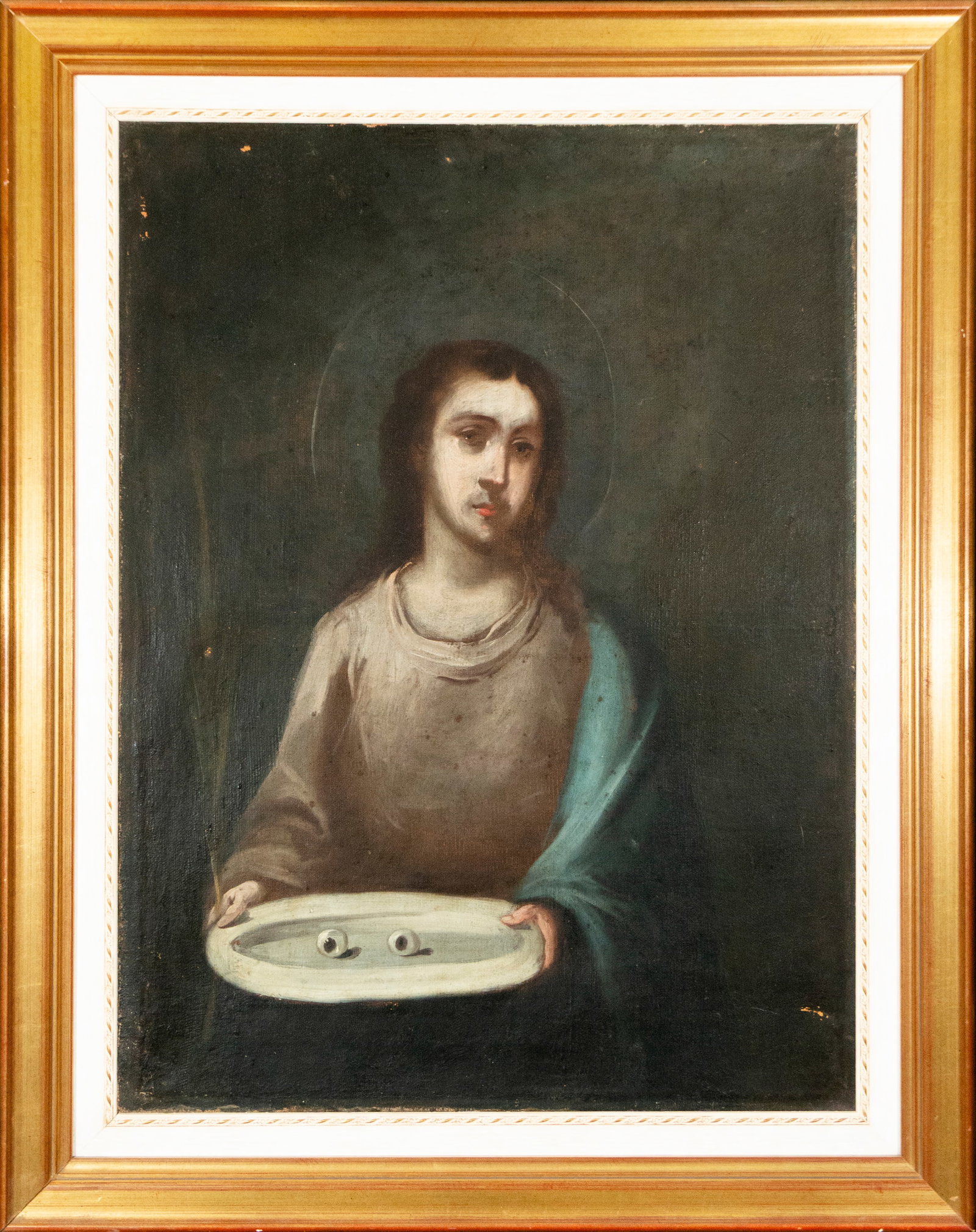 Saint Lucy, Spanish School, 19th Century: Oil on canvas. Depiction of Saint Lucy in a frontal position holding a tray with her martyrdom symbols, highlighting the eyes that iconographically identify the saint. The figure appears enveloped in 