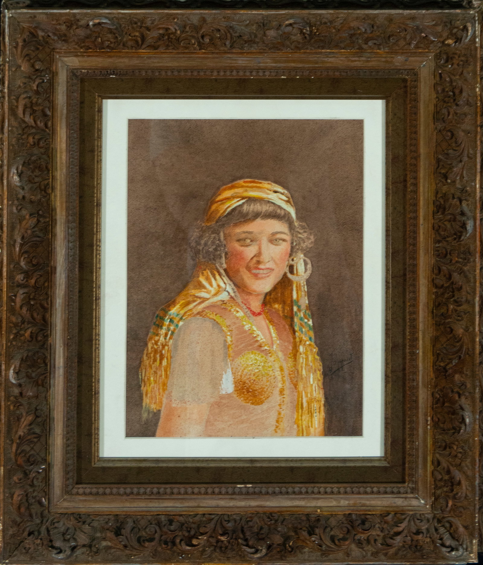 Portrait of an Oriental Woman, signed Joaquín Agrasot. Spanish School. 20th century.: Watercolor on paper. Dimensions: 35 x 26 cm. Bust portrait of a woman wearing a headdress, circular earrings, and clothing with oriental overtones. Her expression is lively and smiling, with loose bru