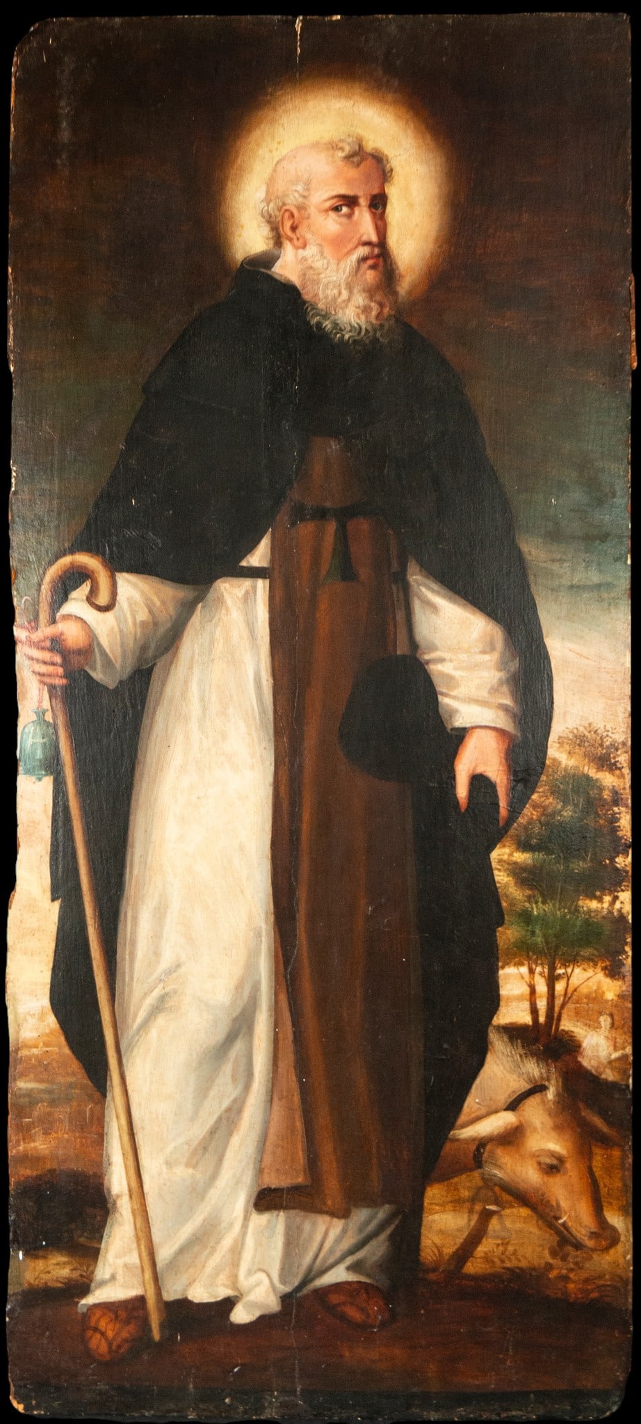 Saint Anthony Abbot, Italian-Flemish School of the late 16th - 17th century: Oil on panel. Dimensions 129 x 56 cm. Saint Anthony Abbot appears standing in monastic habit, with a golden halo and abbot's staff, accompanied by the pig, his most characteristic iconographic attribu