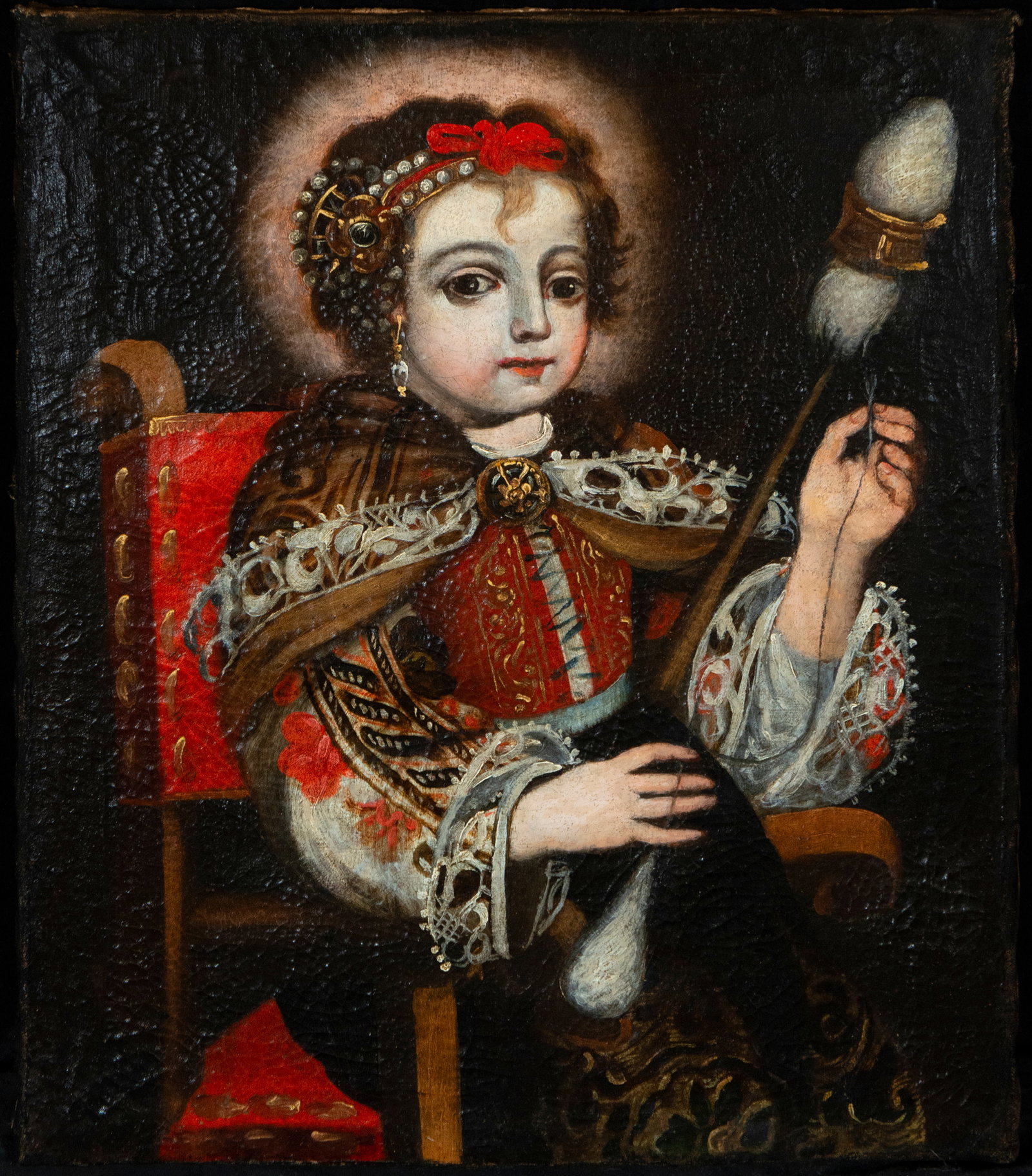 Virgin Spinner. New Spanish School. 17th Century: Oil on canvas. Dimensions: 47.5 x 39 cm. A unique image of the Virgin Mary in her advocation as the Spinning Virgin, seated beside a spinning wheel and holding the spindle as a symbol of industriousne