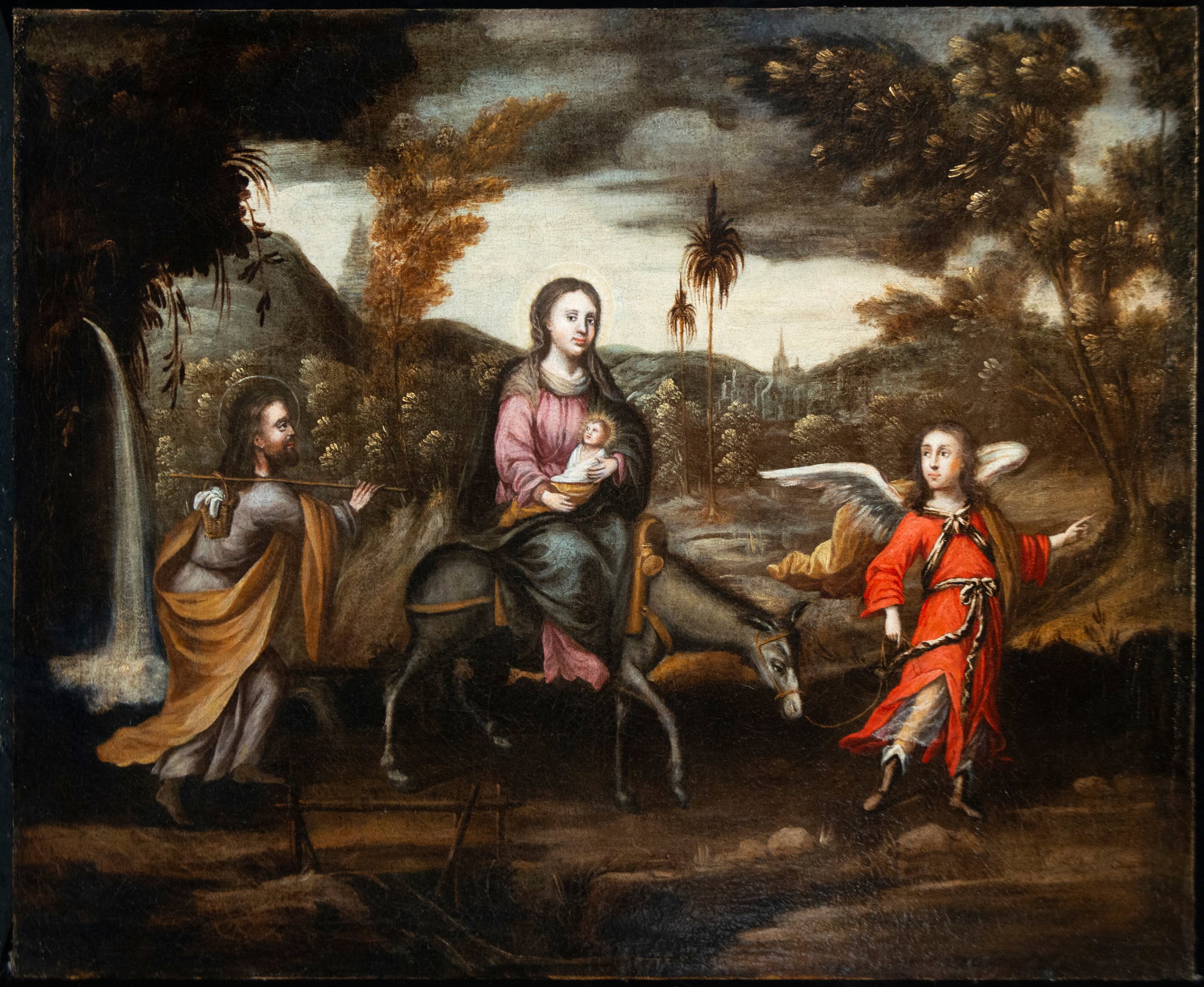 Landscape with the Flight into Egypt. COLONIAL SCHOOL - MEXICO - 18TH CENTURY: Oil on relined canvas. Dimensions: 82.5 x 104 cm. The Holy Family walks through a wooded landscape, guided by an angel, during the Flight into Egypt. The vastness of the natural setting and the arrang