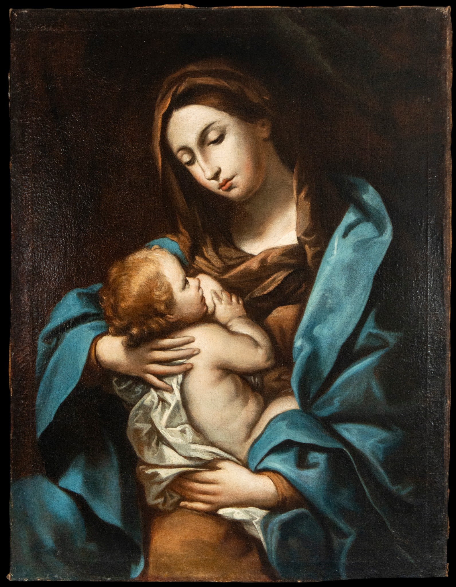 Virgin and Child. Bolognese School, circle or workshop of Guido Reni. 17th century: Oil on canvas. Dimensions 96 x 74 cm. A highly refined devotional composition depicting the Virgin lovingly holding the Christ Child in an intimate dialogue of glances and gestures. The Virgin gently 