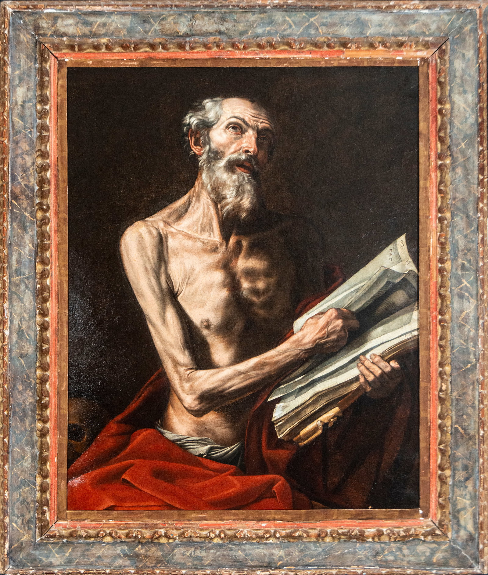 Saint Jerome in Penitence - Neapolitan Master of the 17th Century - Neapolitan School. 17th Century: Oil on canvas. Dimensions 100 x 81 cm. The painting depicts Saint Jerome in his old age, engrossed in reading the Holy Scriptures while gazing at a transcendent vision beyond this earthly realm. The f