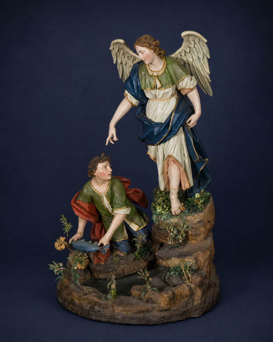 STAR LOT - Attributed to NICOLA FUMO (Salerno 1647 - Naples, 1725) Archangel Saint Raphael and: Neapolitan School, 17th to early 18th century - Polychrome wooden sculpture group. Dimensions: 53 x 30 x 34 cm. The scene depicts the Archangel Raphael guiding the young Tobias during the episode narr